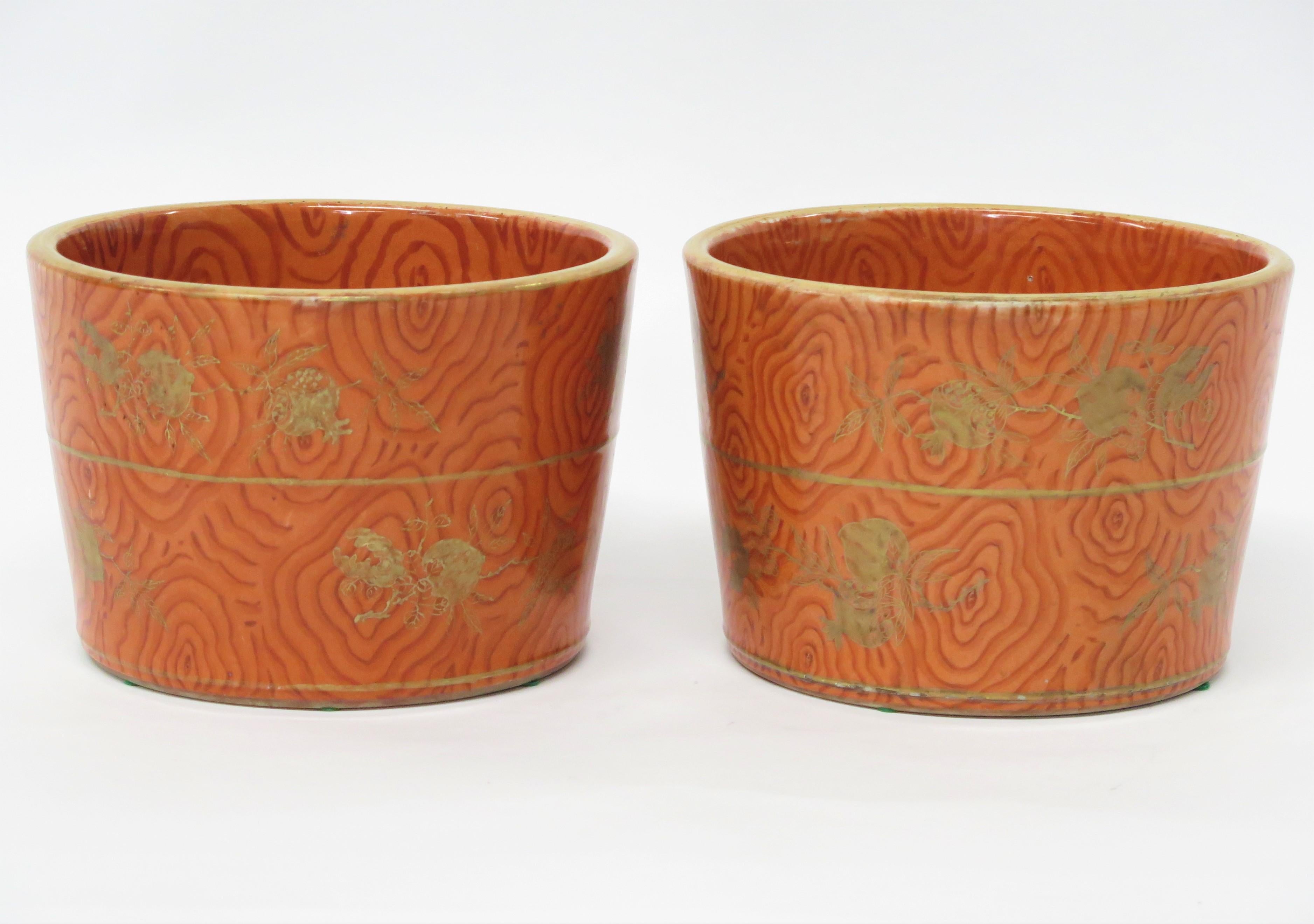 a pair of Chinese iron-red and gilt ''faux bois'' jardineres molded in the shape of a wooden bucket with scattered floral sprays, single hole for drainage, QING DYNASTY, China. 19th century   

Ann and Gordon Getty Collection  

Christie's Sale Oct.