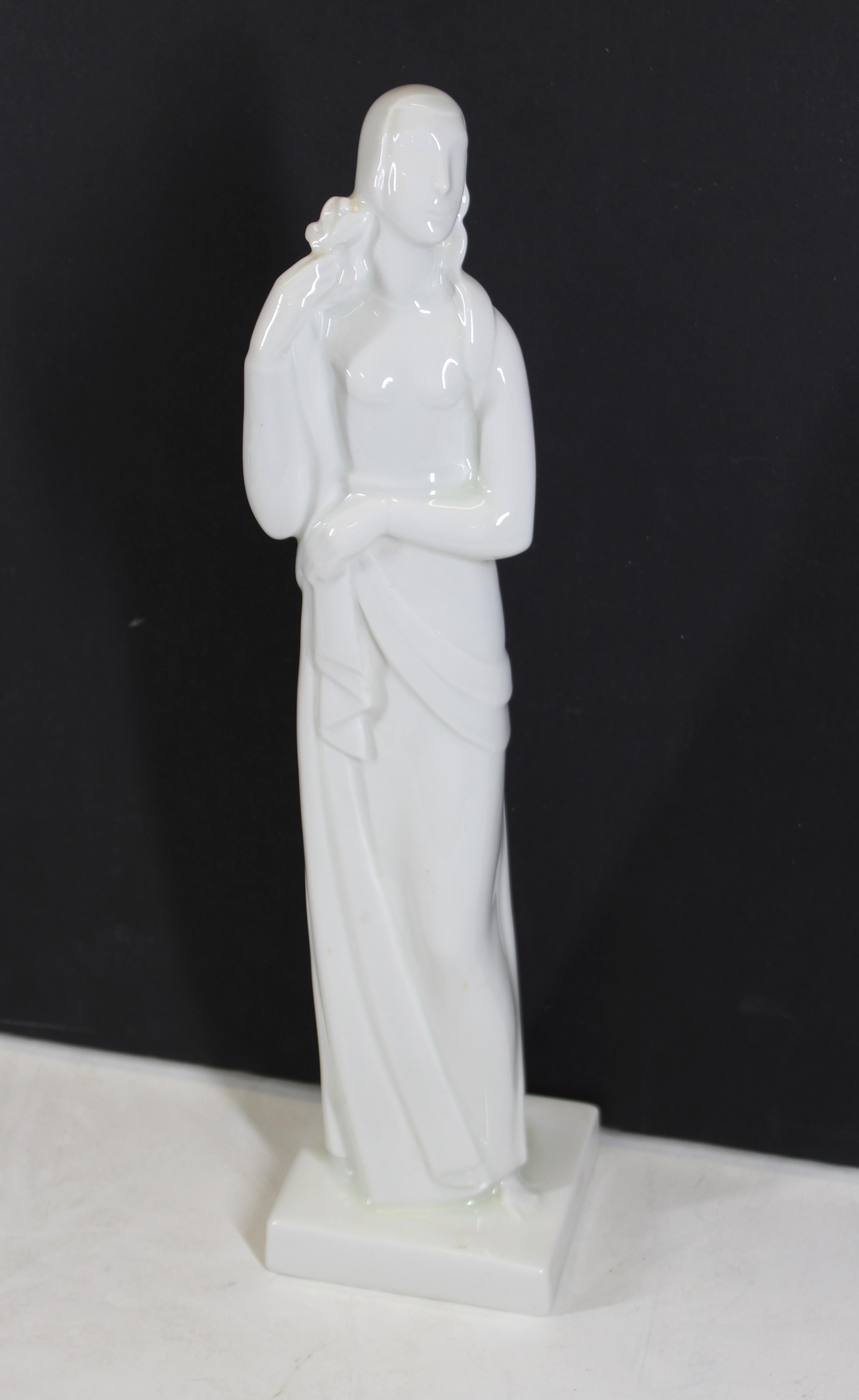 American Art Deco period rare glazed white porcelain figure of a standing woman, designed by famed ceramicist Geza De Vegh for the Lamberton ceramic works in New Jersey during the 1930s. The piece depicts a woman holding an olive branch, likely an