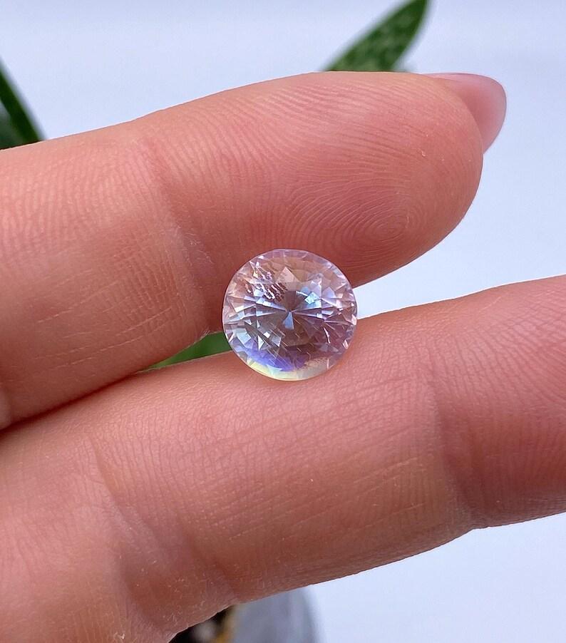 Natural Rainbow Moonstone gemstone

Laboratory GFCO certified
Gemstone Color: White with blue sheen
Gemstone Type: Moonstone
Gemstone size: 9.41x9.19x8.06mm
Cut Grade: Very Good
Gemstone Shape: Oval brilliant Cut
Gemstone Creation: Natural
Gemstone