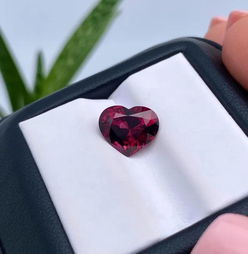 Natural Garnet Rhodolite gemstone

GFCO Laboratory certified
Gemstone Color: VIVID purplish red
Gemstone Type: Garnet Rhodolite
Gemstone size: 9.08x10.72x6.04mm
Cut Grade: Very Good
Clarity/Grade: VS
Gemstone Shape: Heart brilliant cut
Gemstone