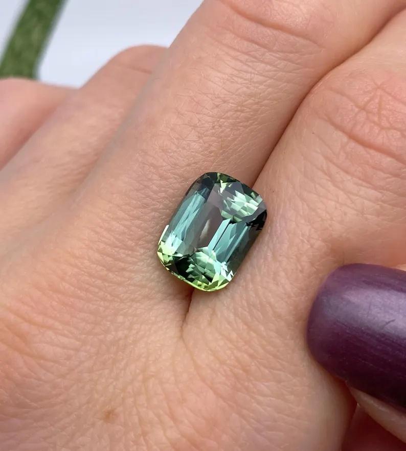 Natural Tourmaline gemstone

Certificate GFCO
Gemstone Color: slightly bluesh-GREEN
Gemstone Type: Tourmaline
Gemstone size: 12.43x9.42x7.21mm
Cut Grade: Very Good
Clarity/Grade: VVS
Gemstone Shape: cushion cut
Gemstone Creation: Natural
Gemstone