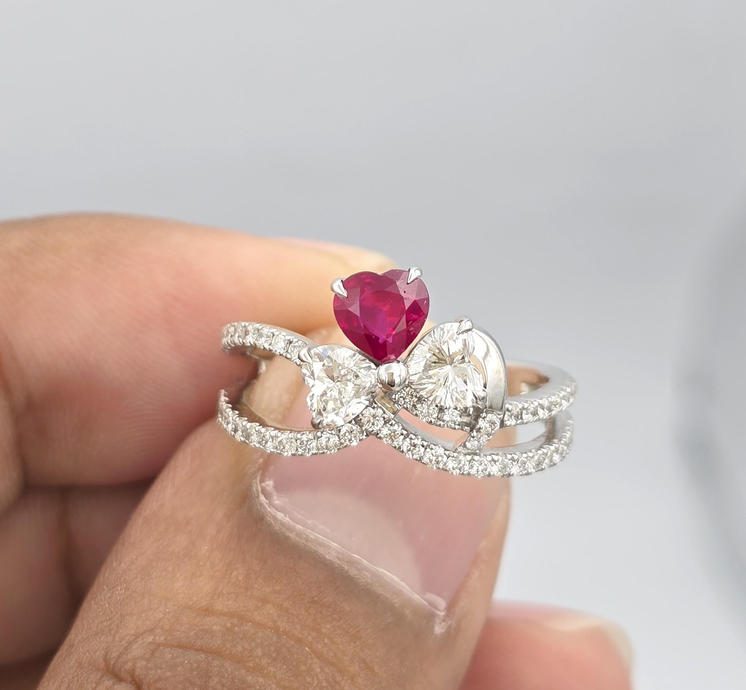 18kt white gold ruby ring with diamonds
  
  Gold colour & karat: White gold 18kt
  Weight: 4.335grams
  
  Set with-
  Stone type: Sapphire
  Shape: Heart
  Carat: 0.55
  Colour: - 
  Clarity: -
  
  Surrounding Stones: Diamonds
 1) Side Heart