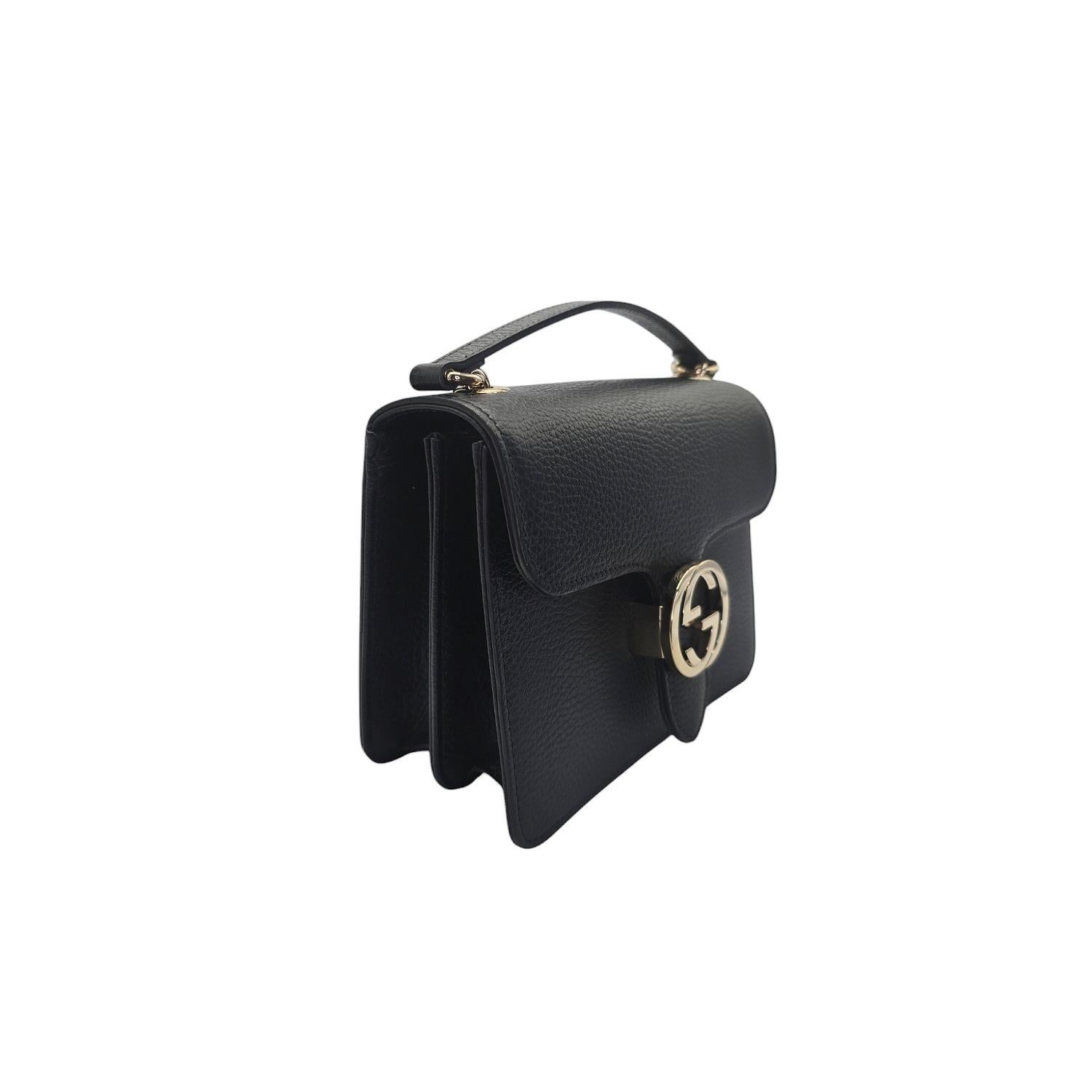 Indulge in luxury with the Gucci Dollar Calfskin Interlocking G Small Shoulder Bag. Crafted from grained black calfskin leather, this elegant bag features a polished light gold chain shoulder strap with a matching interlocking G flip-lock. The