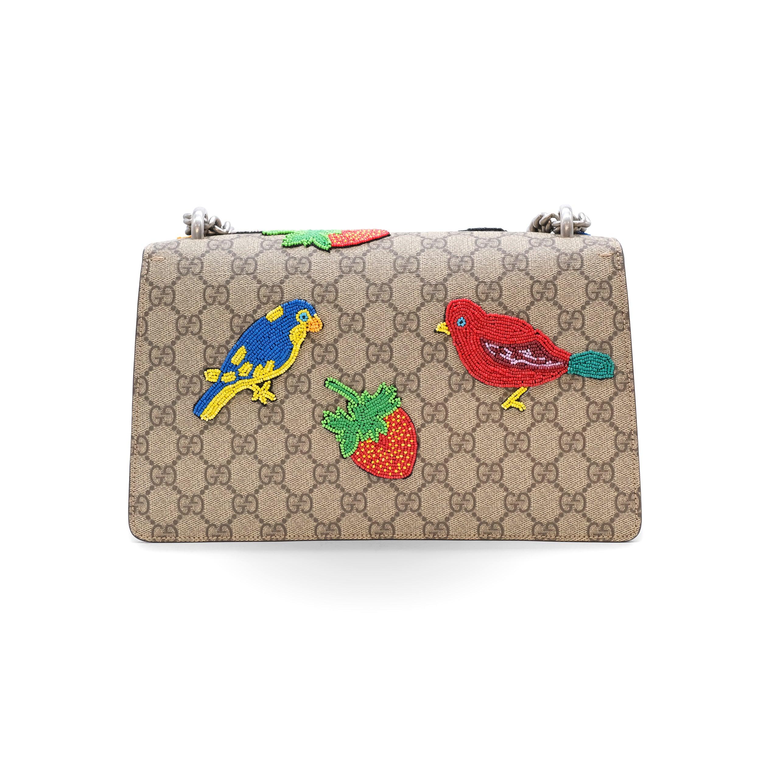 The Gucci Dionysus Small Shoulder Bag is a masterpiece of design and heritage, crafted in the brand's signature GG Supreme coated canvas. This iconic piece is adorned with an antiqued metal tiger head clasp, a nod to the Greek god Dionysus. The bag