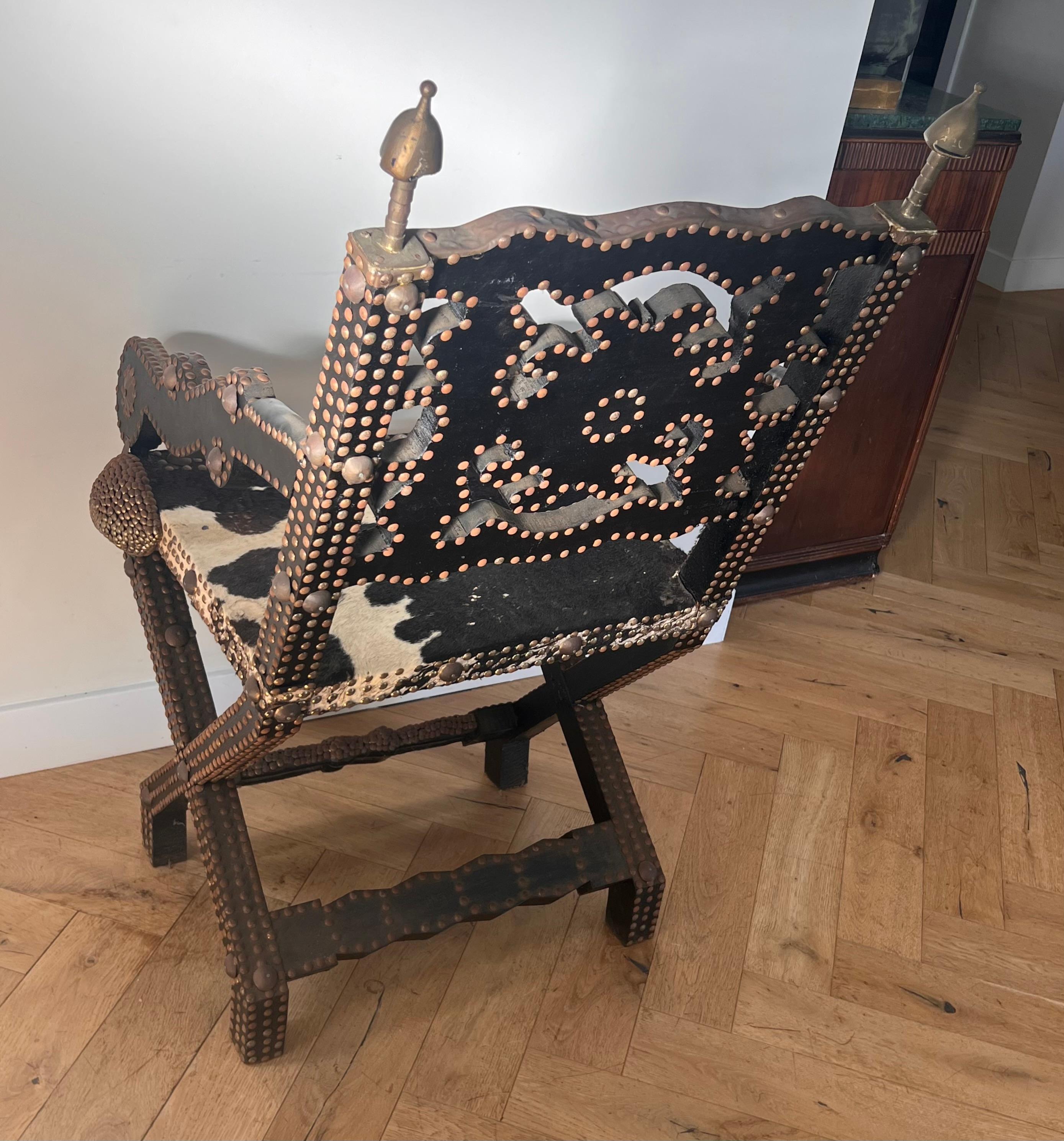 Tribal Ghanaian wood, iron, and cowhide chair, early 20th century For Sale