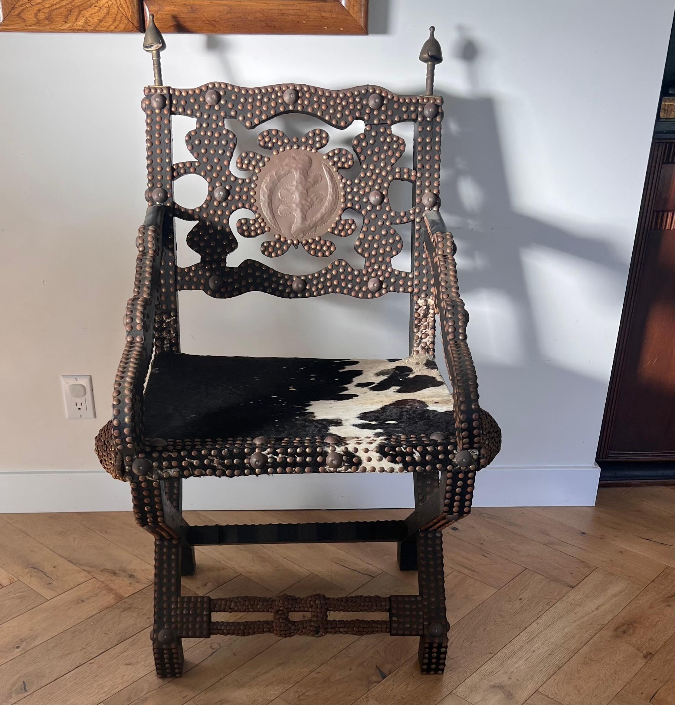 Cowhide Ghanaian wood, iron, and cowhide chair, early 20th century For Sale