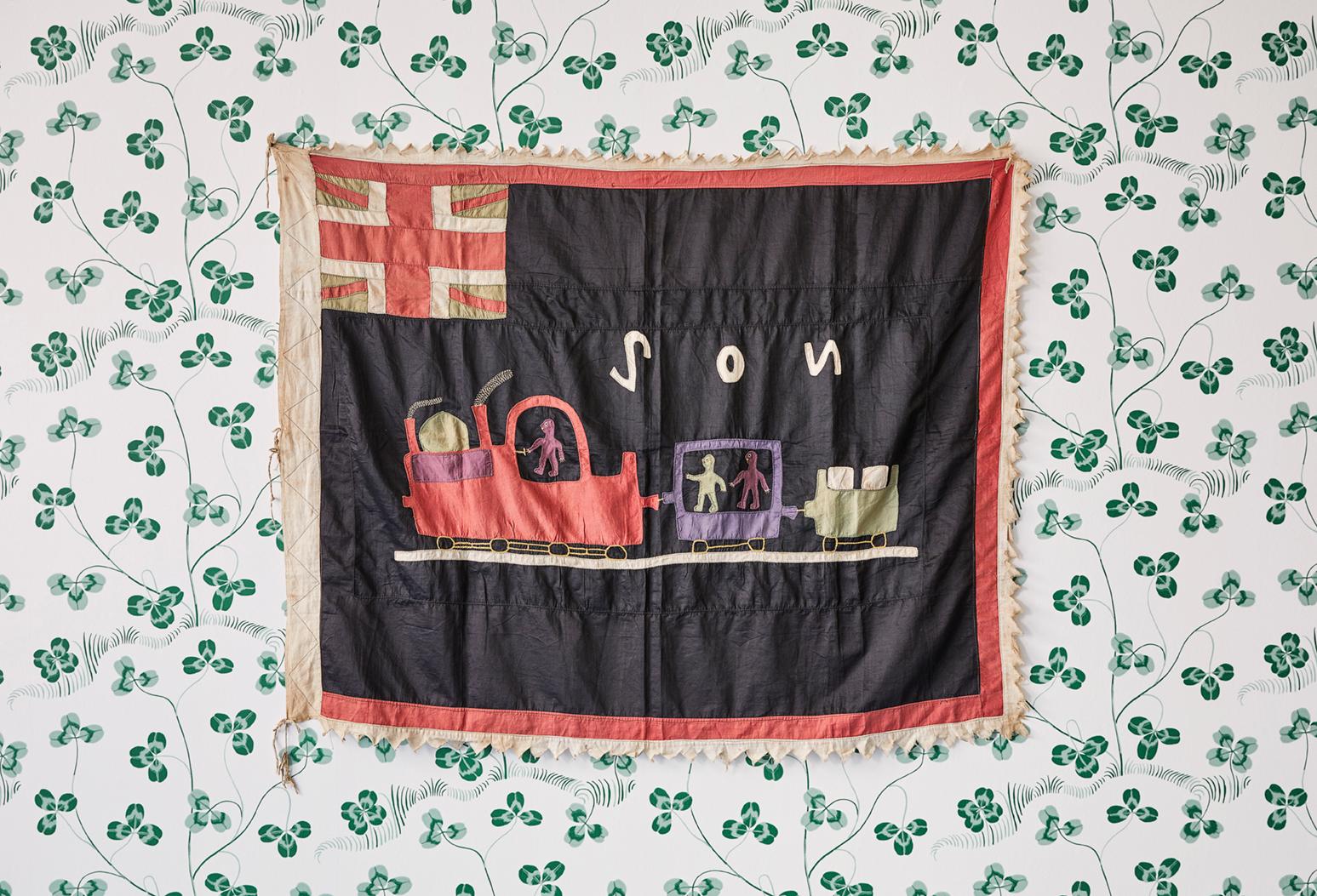 Asafo flag “The train is always ready to go” in cotton applique patters. Trains were a dramatic expression of power, regularity and reliability and as such were a popular theme on Fante Asafo flags after the first railway was built in Ghana in 1901.