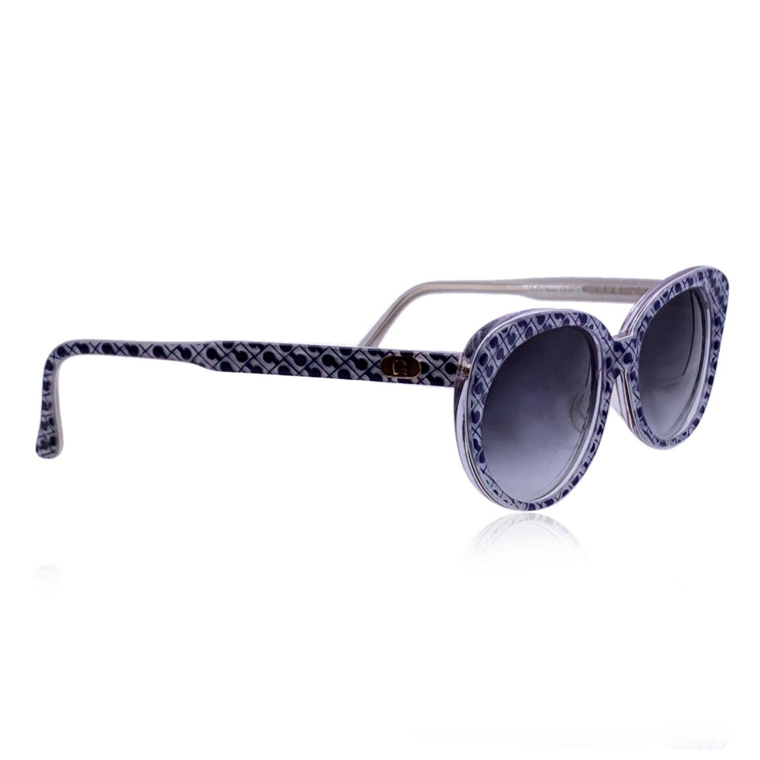 Vintage Gherardini sunglasses mod. Bleu - G/1. White and Blue acetate frame with logo pattern. Original 100% Total UVA/UVB protection in gradient grey color. Gherardini logo on temples. Made in Italy Details MATERIAL: Acetate COLOR: Grey MODEL: