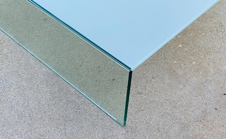 Beautiful glass coffee table designed by Piero Lissoni and manufactured in Italy by Glas Italia.

The table is made all in glass and the top part is not clear unlike the sides which gives it a very stunning look.

The table is in very good