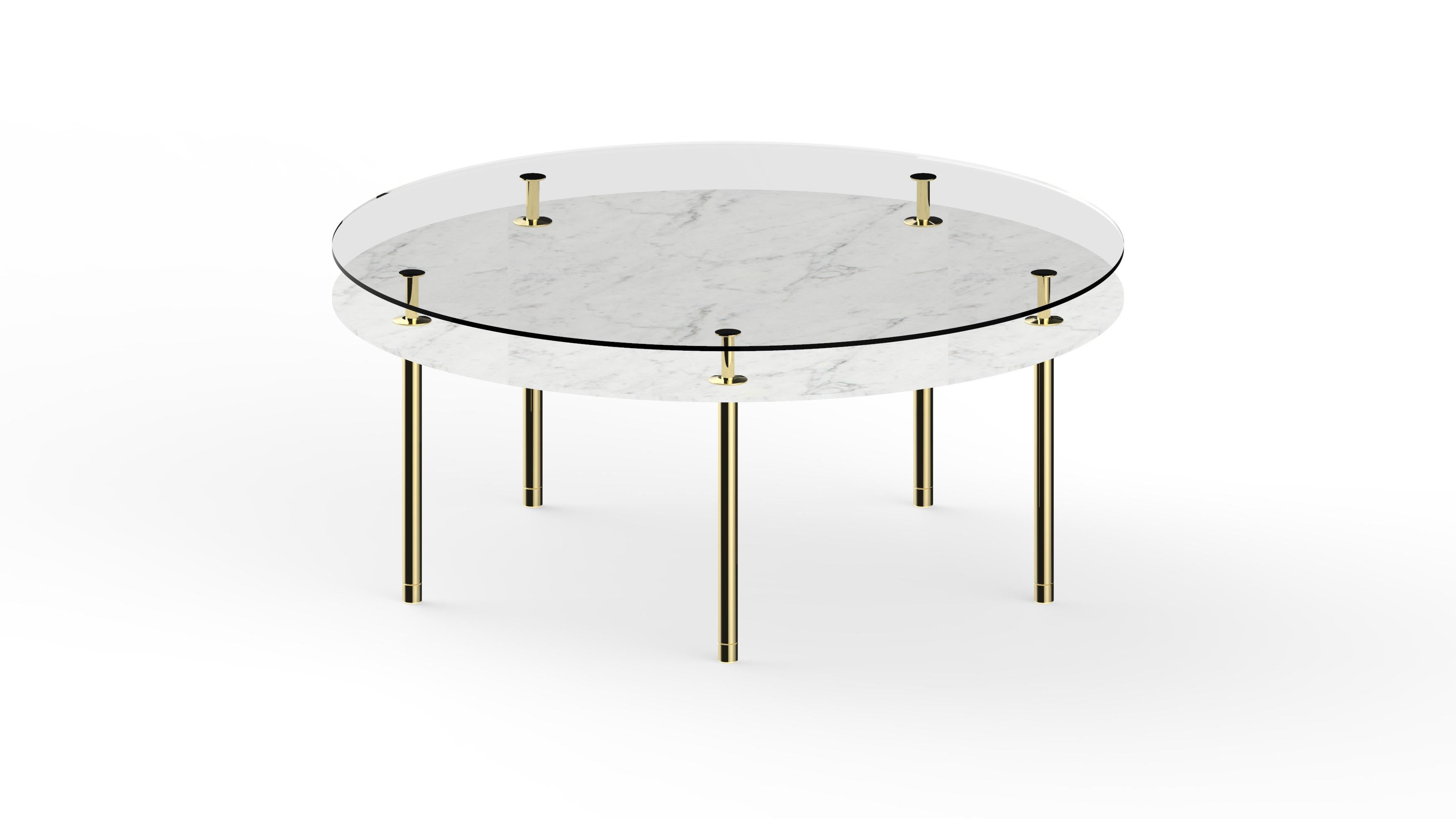 Round table in crystal and brass. The designer imagines a turning point in the use of such a precious finishes such as polished brass: from the idea of almost a unique object in its perfect craftsmanship, to the system to be built starting from the