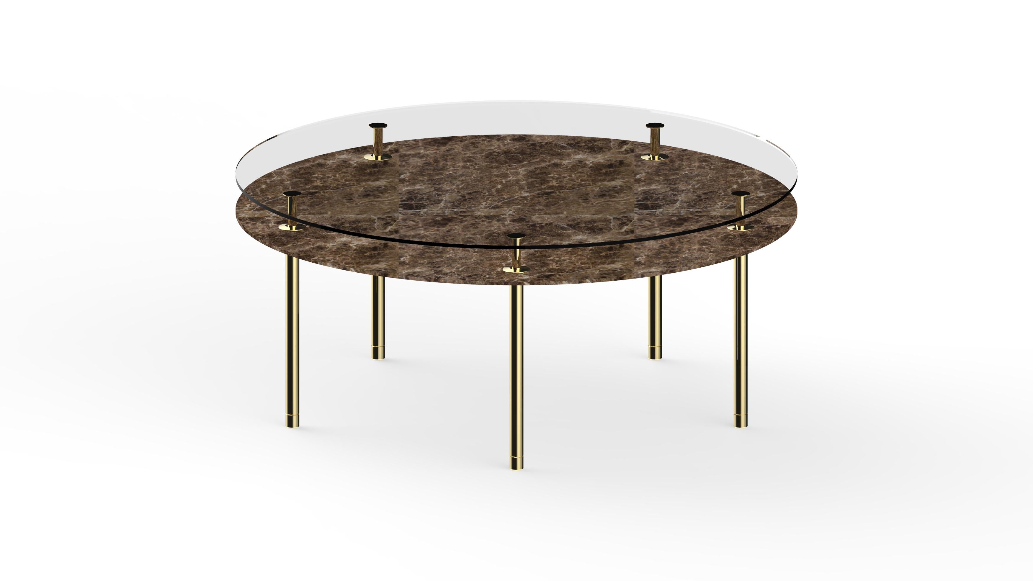 Round table in crystal and brass. The designer imagines a turning point in the use of such a precious finishes such as polished brass: from the idea of almost a unique object in its perfect craftsmanship, to the system to be built starting from the
