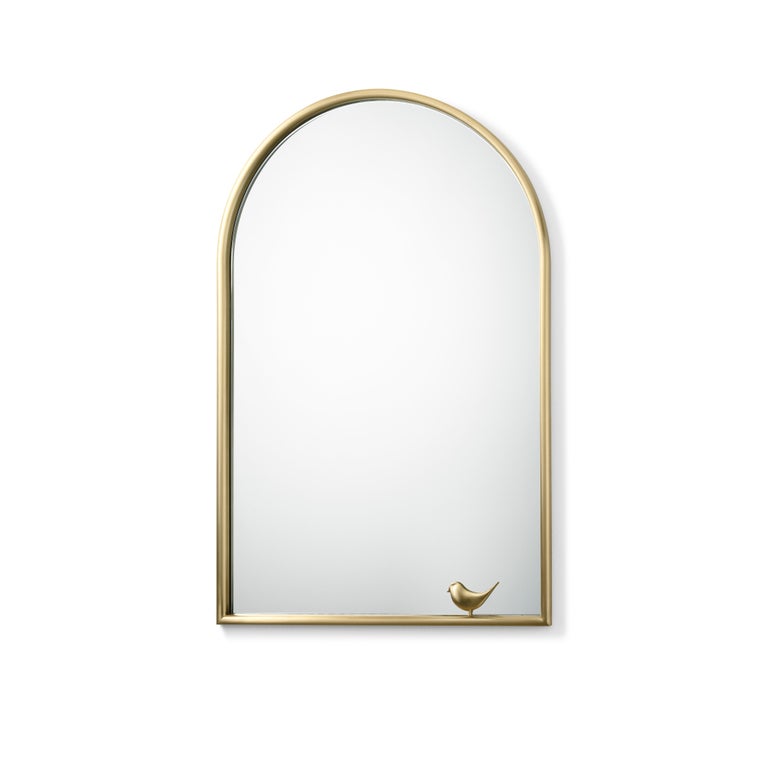 Mirror with decor and brass frame. A Classic Renaissance monofora is the form that inspired the two mirrors. The arc is defined by brass profile rounded at the bottom, just like on a windowsill to lean on, then a little bird appear: poetic
