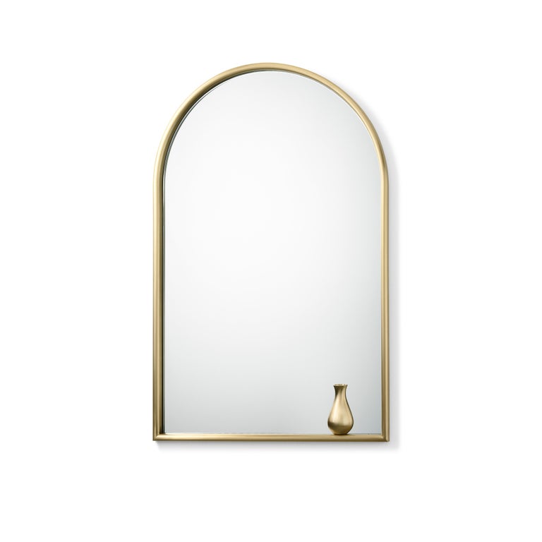 Mirror with decor and brass frame. A classic Renaissance monofora is the form that inspired the mirror. The arc is defined by brass profile rounded at the bottom, just like on a windowsill to lean on, then a jar appear: poetic quotations that lead