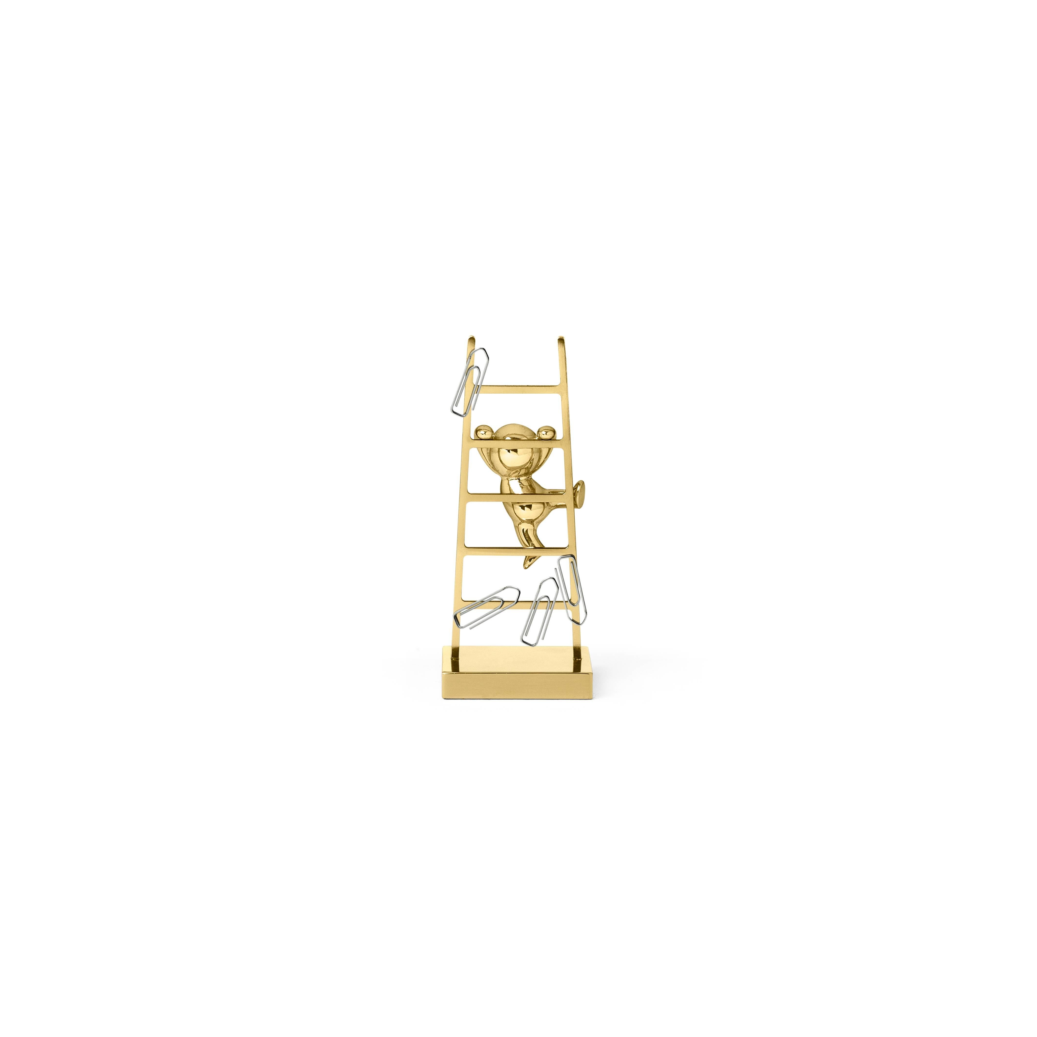 This unconventional paperclip holder is made of brass. This versatile piece features a small, stylized man climbing up a ladder that contains magnets, ensuring that all unruly paperclips scattered across a desk are well stored in one place.