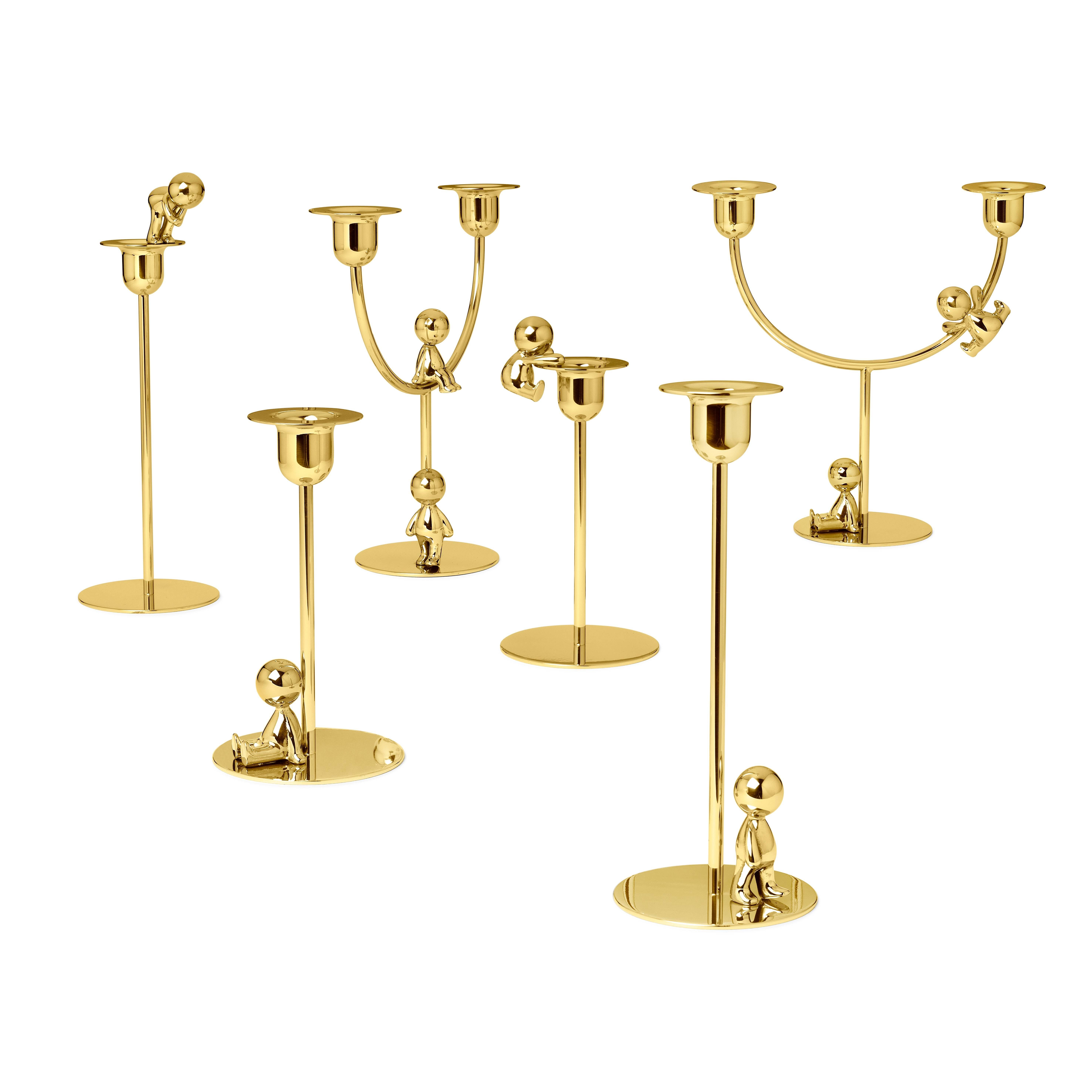 This delightful polished brass short candlestick is a creative accent for any modern interior. Designed for taper candles, the streamlined design boasts a rounded bobeche with a wide rim supported by a short column and a flat base. A small figurine