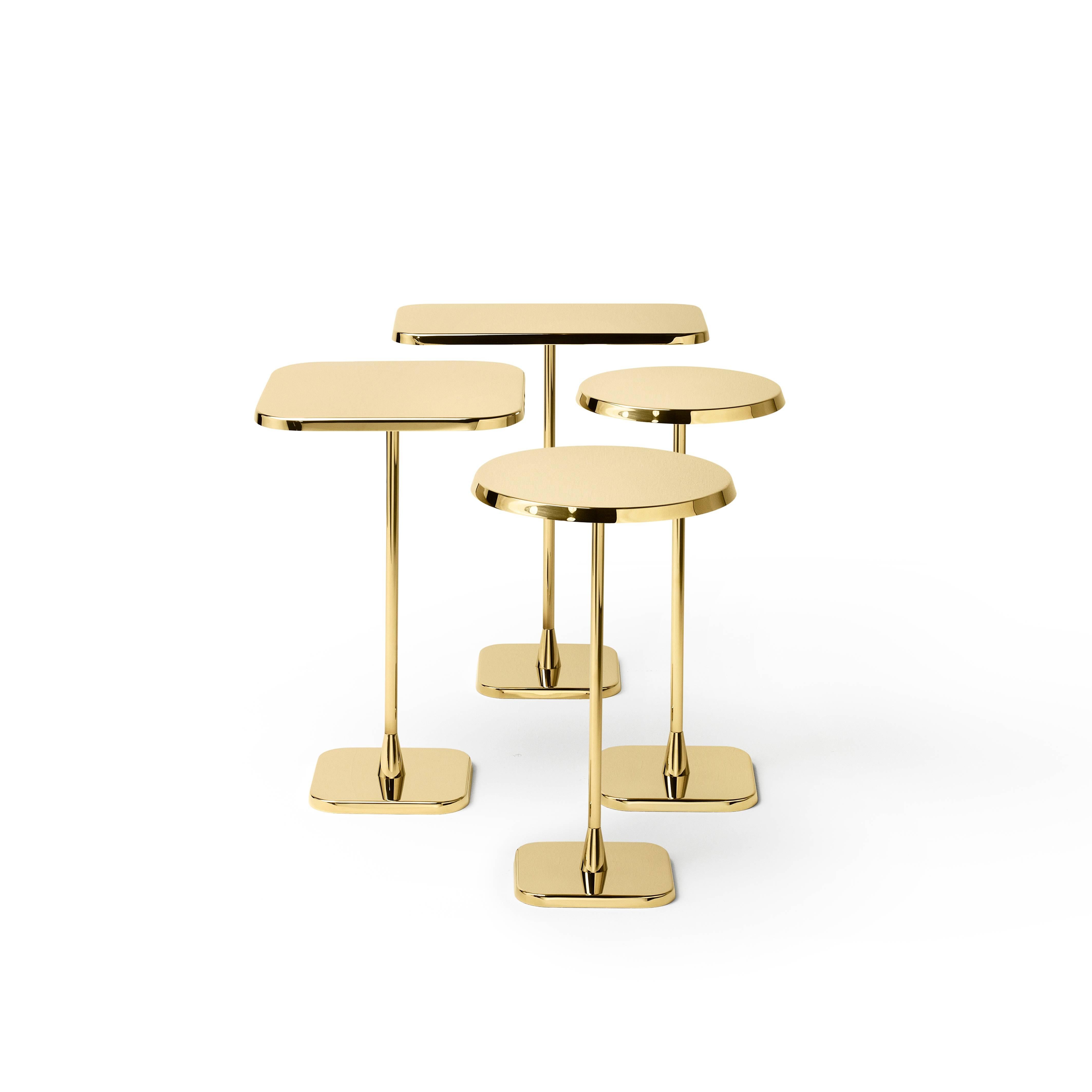 Tall round table in stainless steel finished in polished brass.