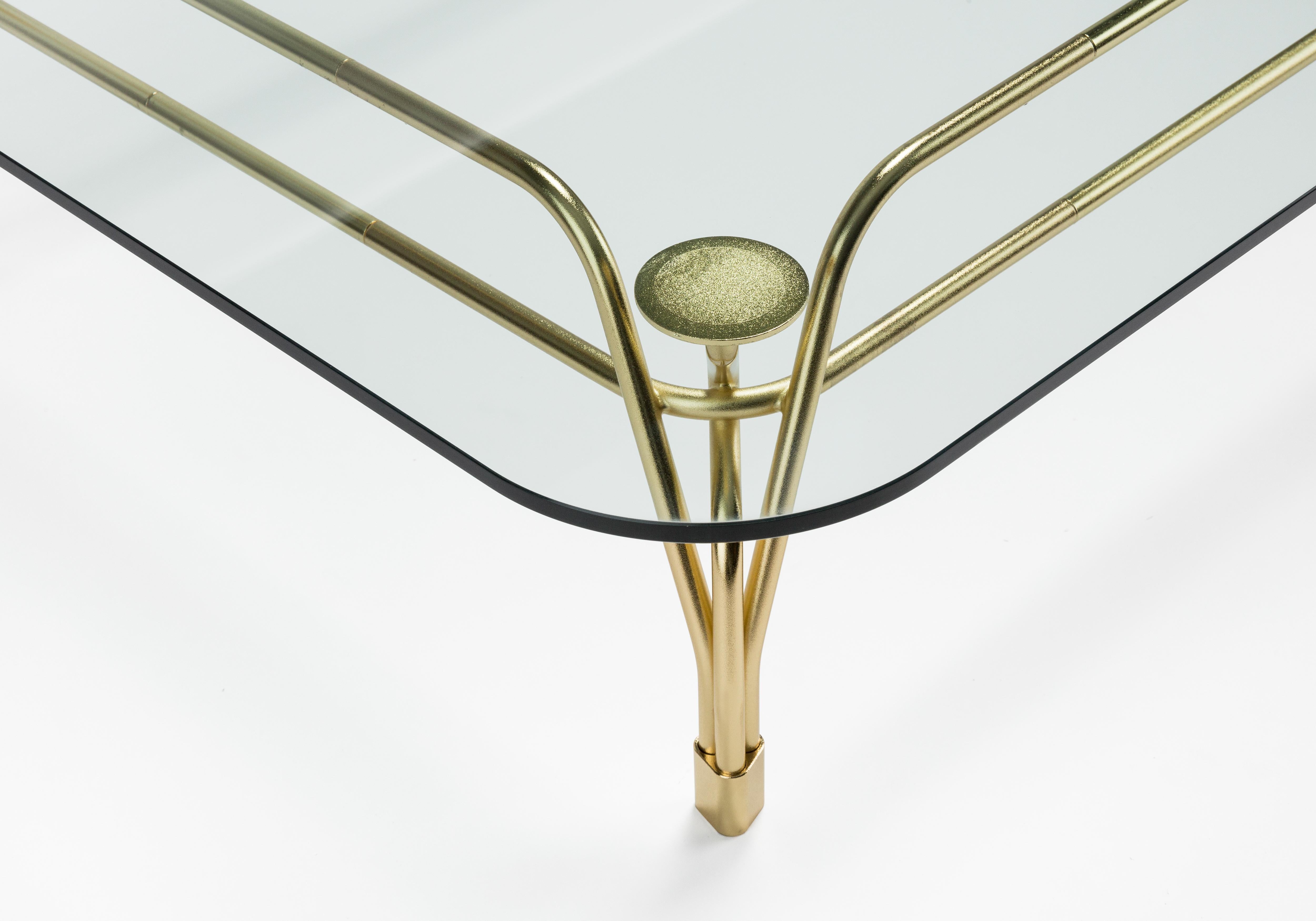 Famille de tables caractérisée par l'élégante structure métallique sophistiquée soutenant le plateau en verre. L'inspiration des meubles d'extérieur du début du siècle rencontre l'artisanat moderne du métal de haute qualité. Le tissage complexe de