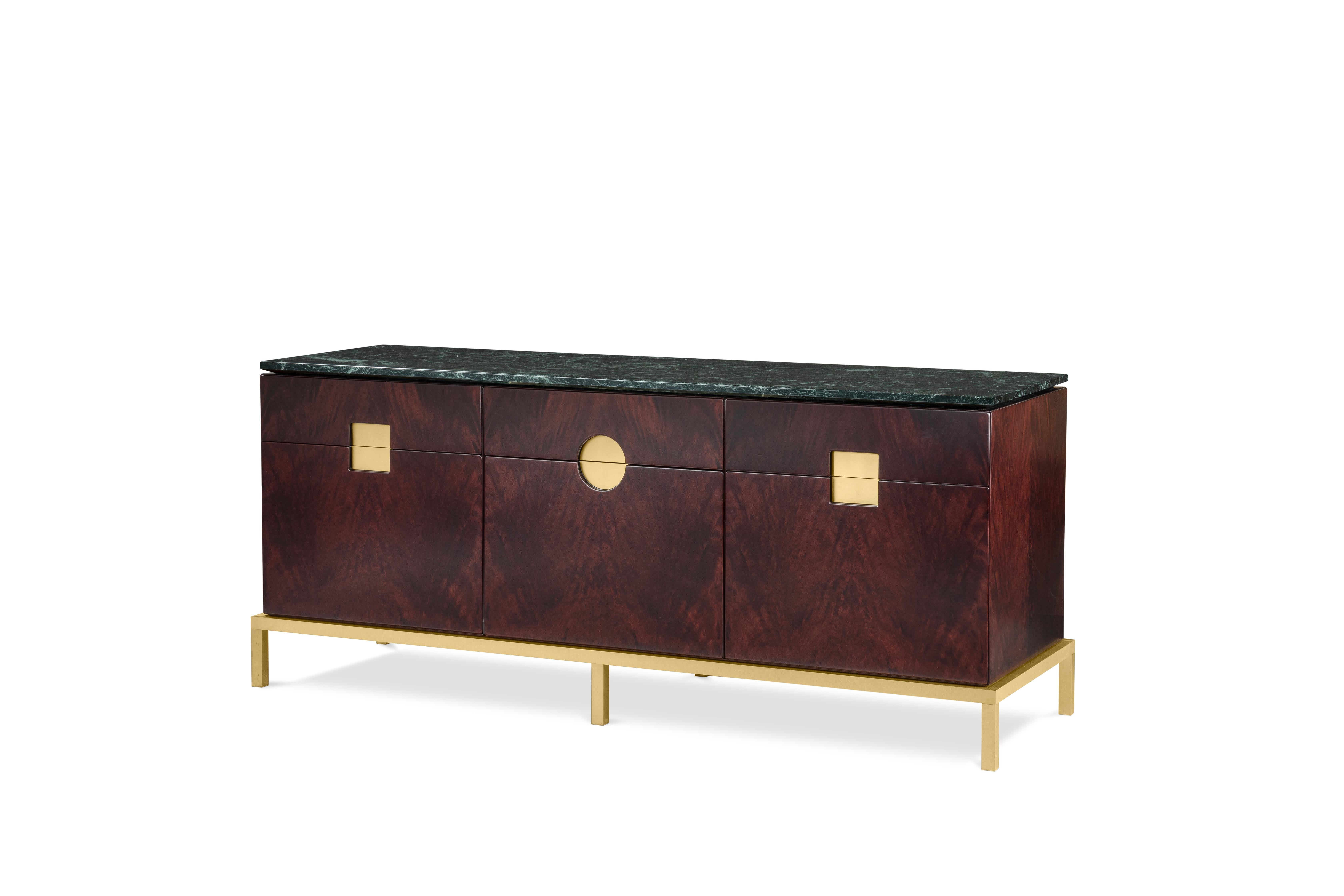 Elegant cabinet with essential lines of Japanese flavour. The slender structure in essence is opposed by four slim legs in gilded metal. Zuan is recognizable by the detail of the support, a quarter of a circle with great aesthetic and functionality,