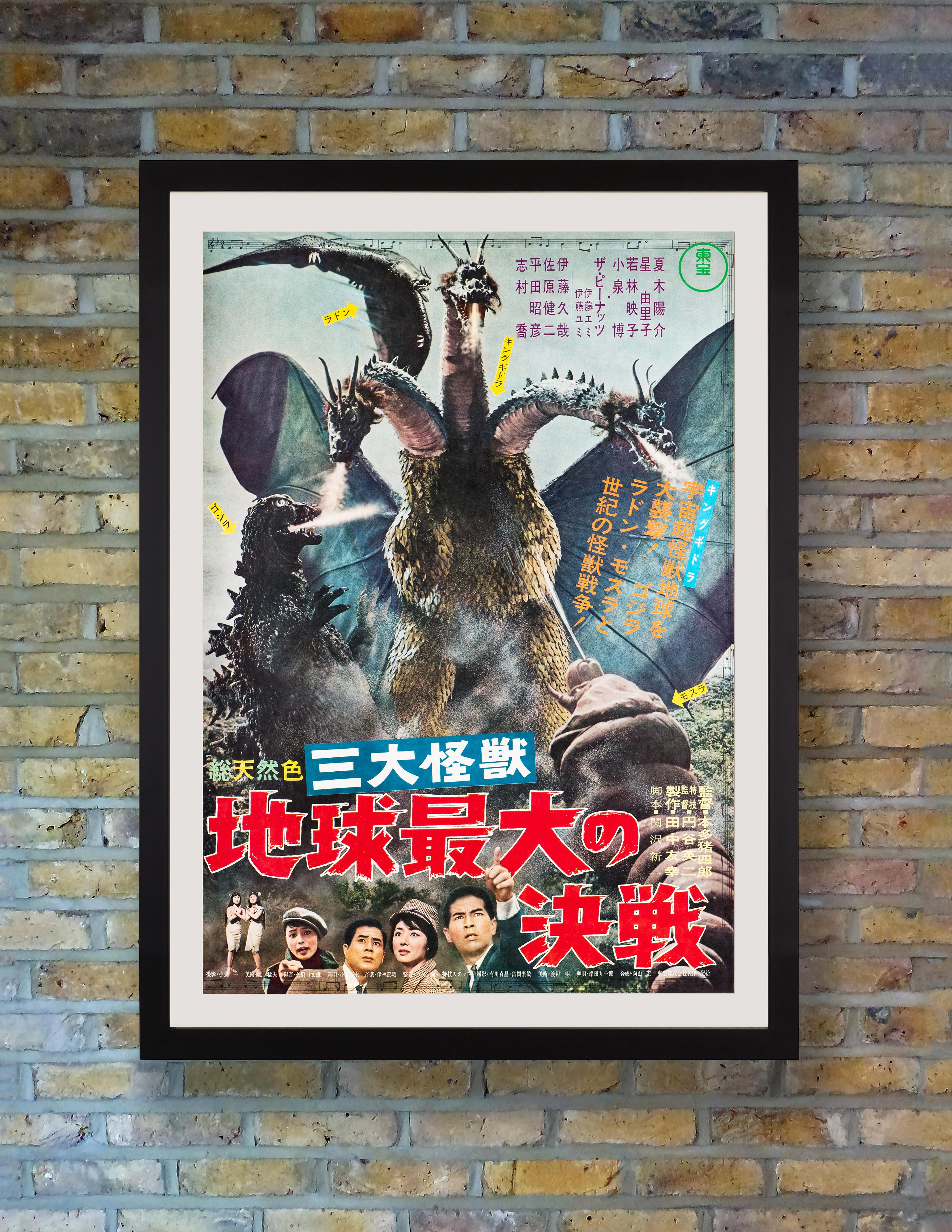 The fearsome three-headed King Ghidorah towers over iconic rival Godzilla on this scarce and surprisingly charming B2 poster for the original release of the popular Japanese kaiju classic 'Ghidorah, the Three-Headed Monster.' 

Inspired by a