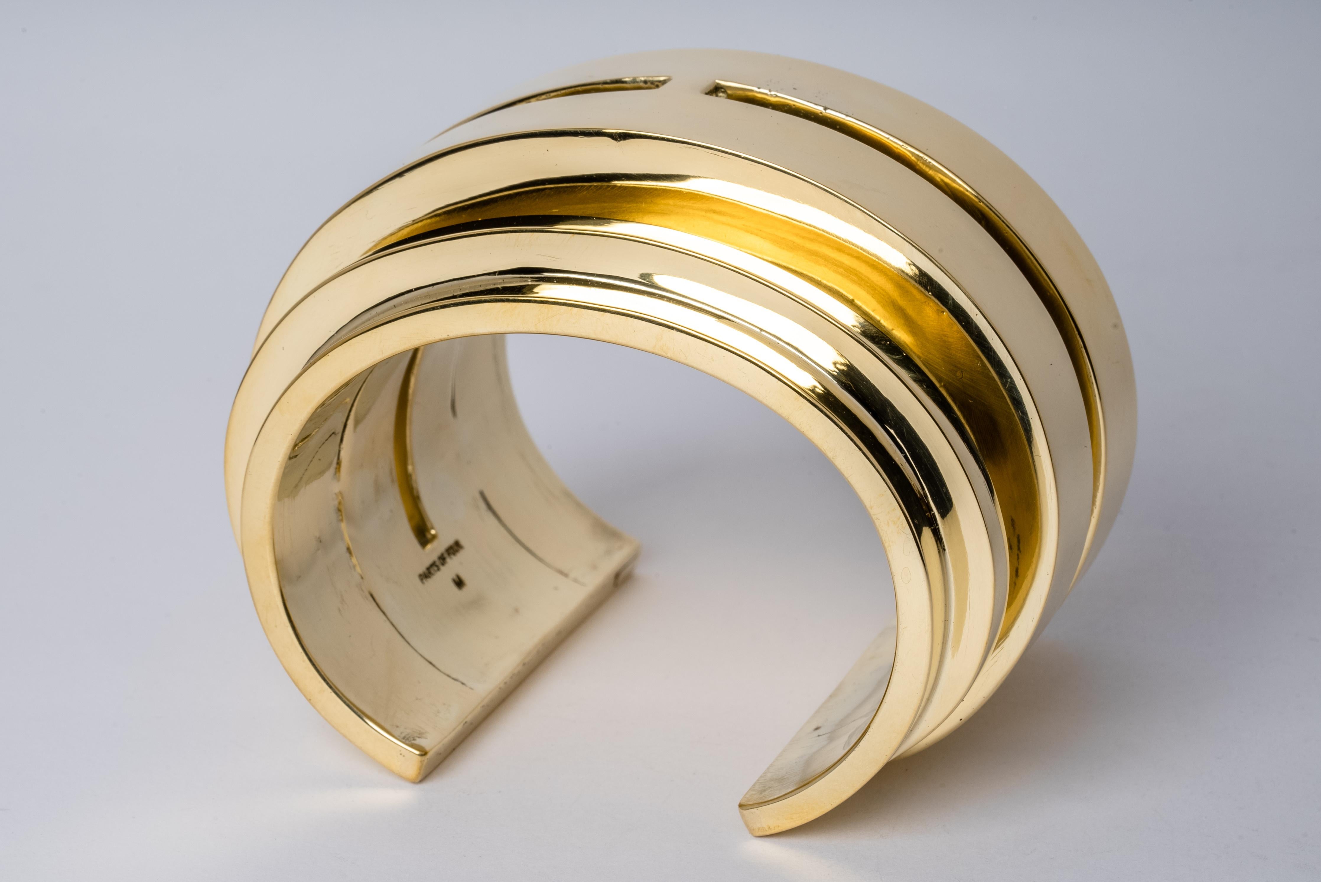Bracelet in polished brass. This piece is 100% hand fabricated from metal plate; cut into sections and soldered together to make the hollow three dimensional form. This series seeks to reduce combinations of forms to their primary silhouettes.