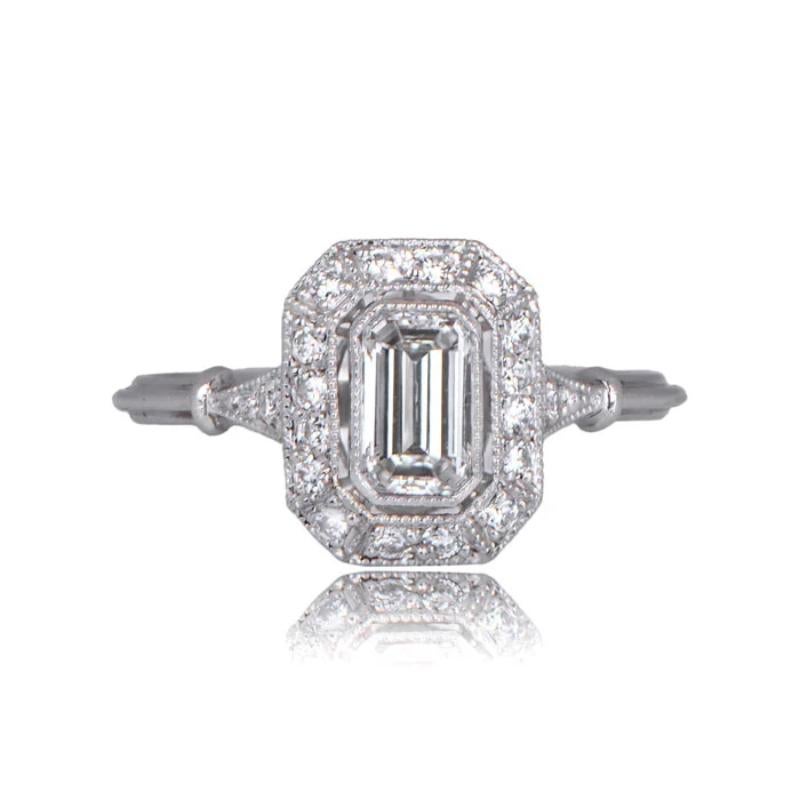 A stunning engagement ring featuring an emerald cut diamond weighing 0.50 carats, I color, VS1 clarity.
The center diamond is adorned by a halo of old European cut diamonds weighing approximately an additional 0.24 carats and is set in a triple-wire