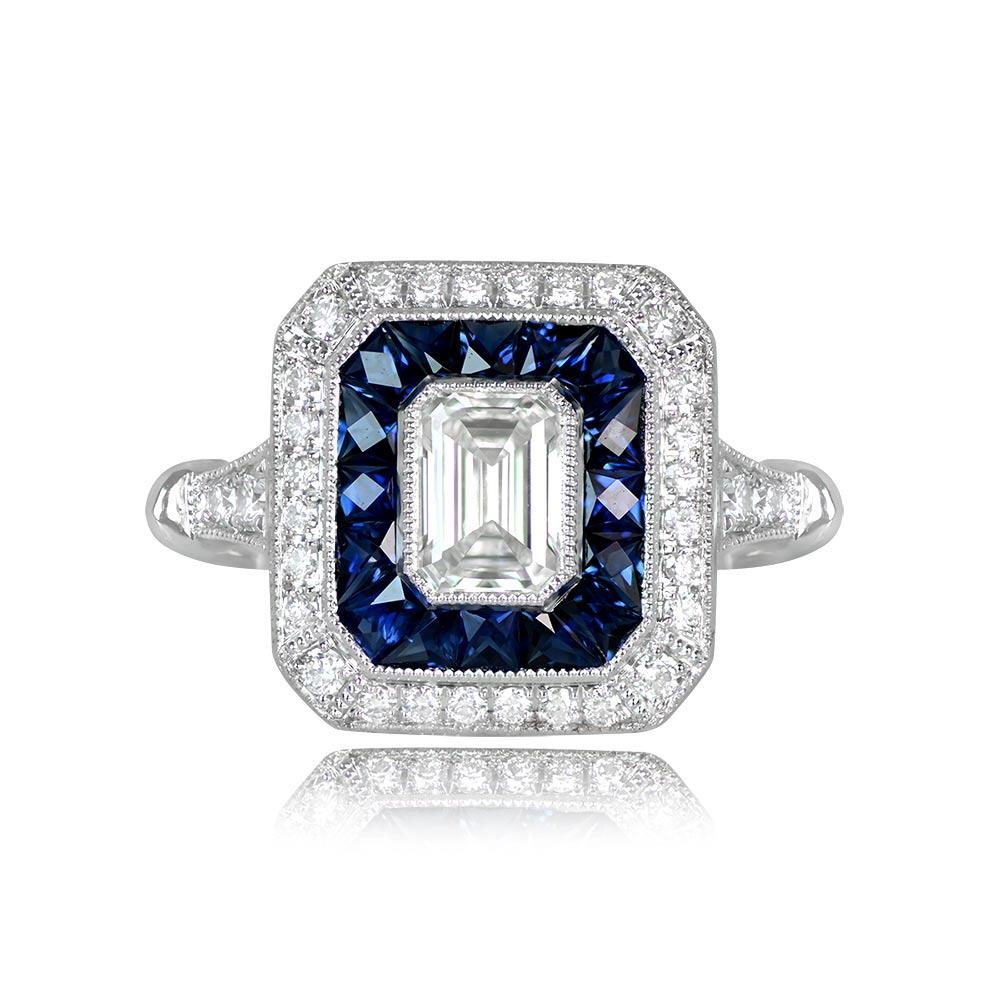 This captivating geometric engagement ring showcases a brilliant GIA-certified emerald cut diamond weighing 0.51 carats, with a G color and VS2 clarity. The center diamond is encircled by a double halo of round brilliant-cut diamonds and French-cut