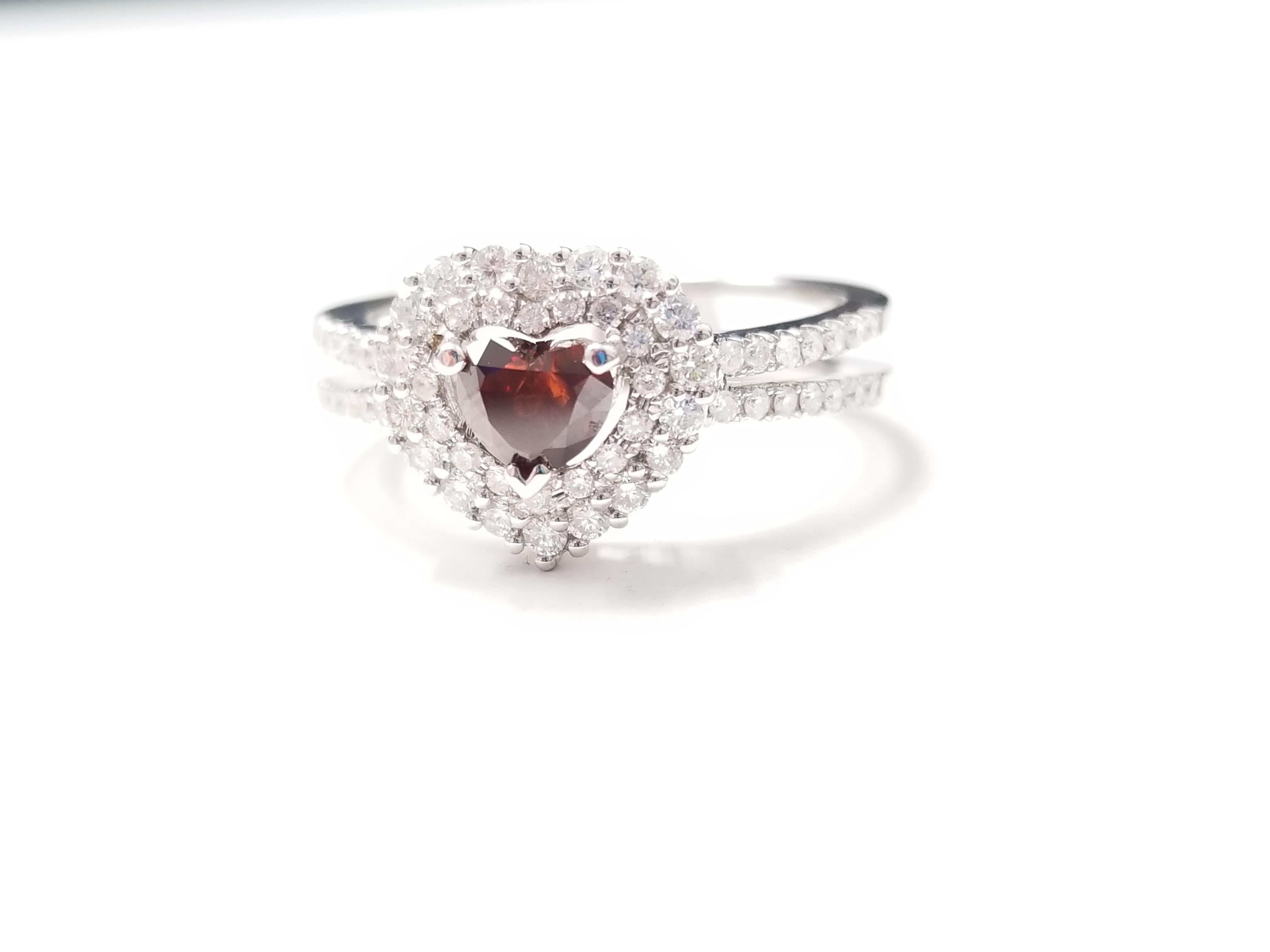 Fancy Reddish Brown Red Face up heart shape natural GIA diamond weighing 0.52 carats. Surrounded by beautiful white diamonds in the halo split setting. Its transparency and luster are excellent. Set on 18K white gold. Ring Size 6.5.