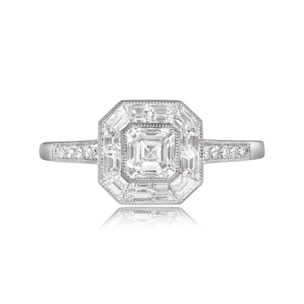 A stunning engagement ring showcasing a GIA-certified 0.52-carat Asscher cut diamond with I color and VS1 clarity, set in a bezel. The center stone is surrounded by a geometric halo of baguette-cut diamonds, with five round-cut diamonds accenting