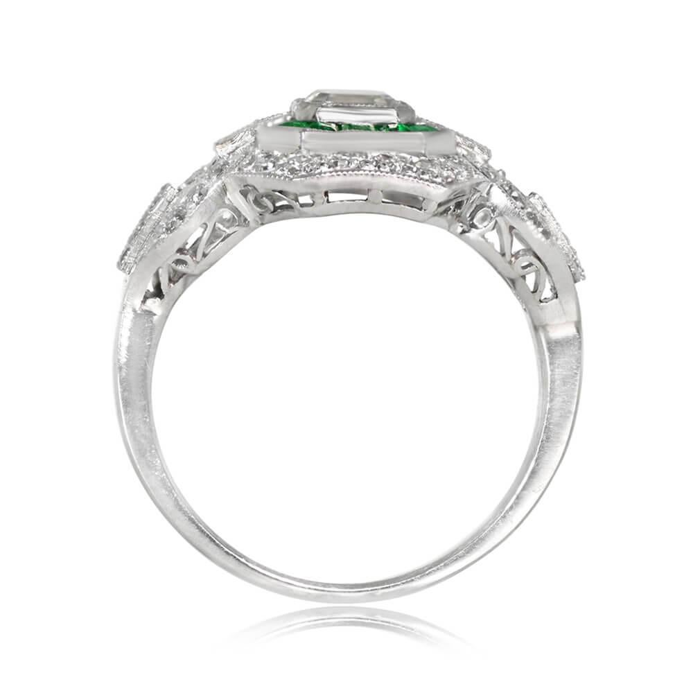 A striking geometric engagement ring showcases a GIA-certified 0.52-carat Asscher cut diamond, J color, and VS2 clarity. The center stone is embraced by a double halo of calibre cut emeralds and old European cut diamonds. Baguette-cut diamonds
