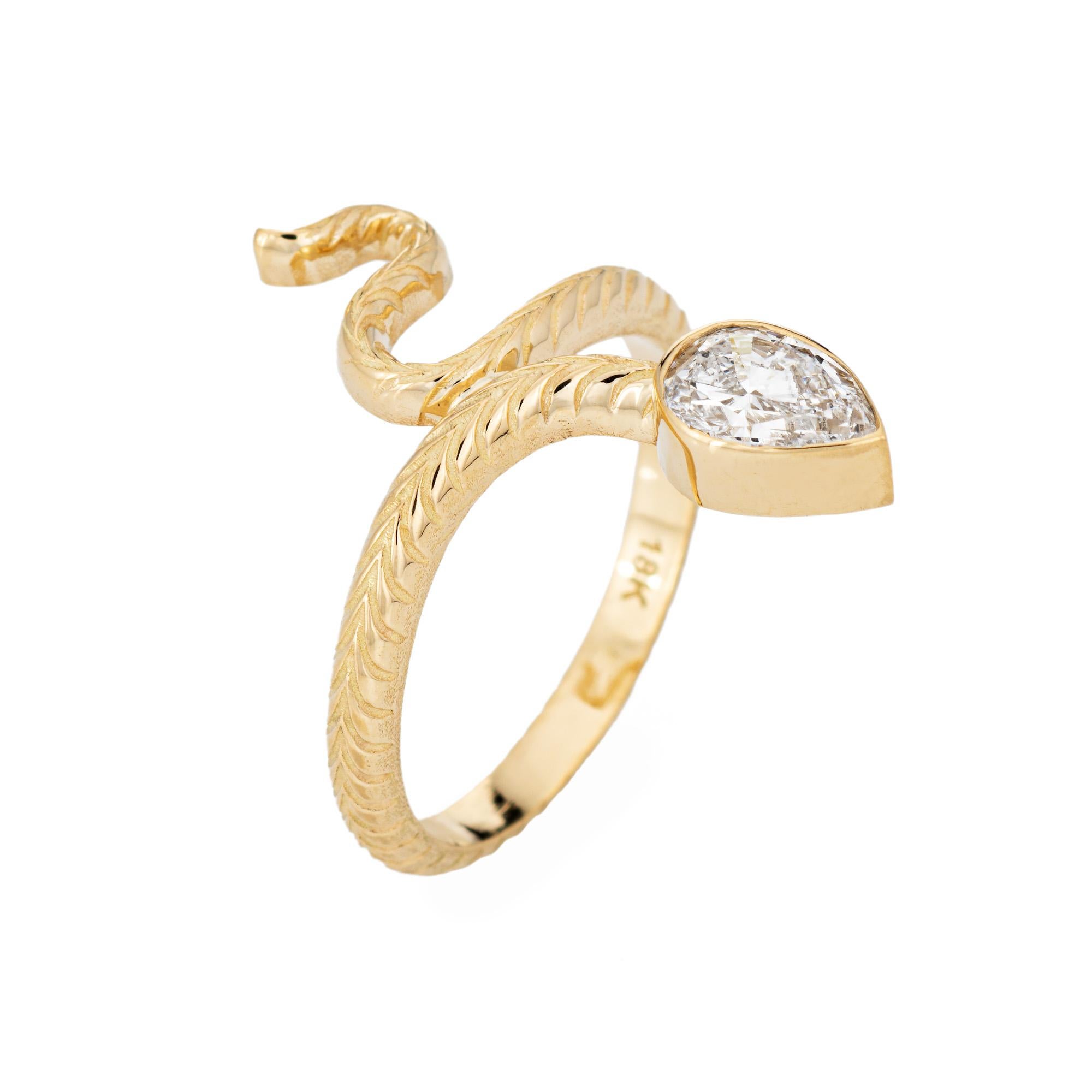 Stylish diamond snake ring crafted in 18 karat yellow gold. 

Pear brilliant diamond measures 6.90 x 4.89 x 2.94mm and weighs 0.58 carats. The diamond is graded D color and SI2 clarity. Also included is a GIA report/certificate.    

For centuries