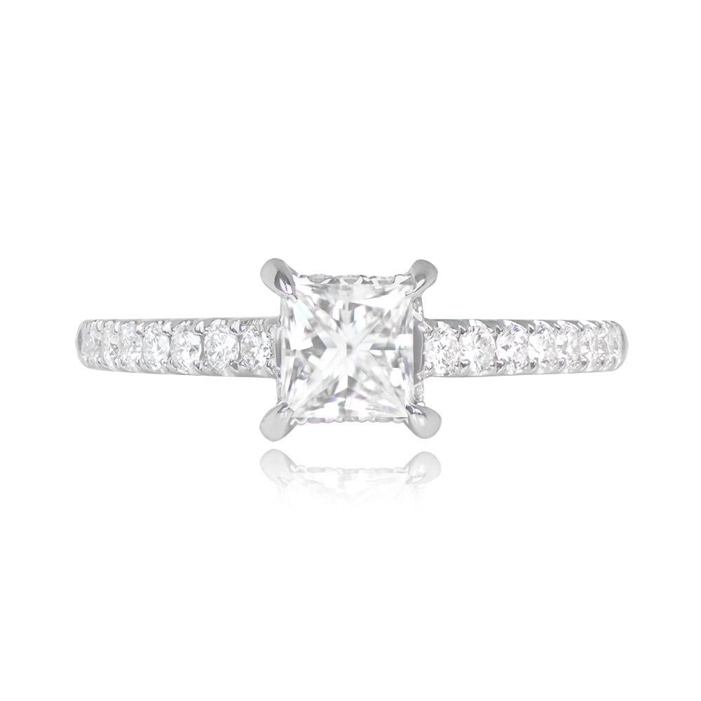 This 18k white gold engagement ring showcases a GIA-certified 0.59-carat, F color, SI2 clarity princess cut diamond set in prongs. Along the shoulders, micro-pave round brilliant cut diamonds add elegance, with a total weight of 0.31 carats.


Ring