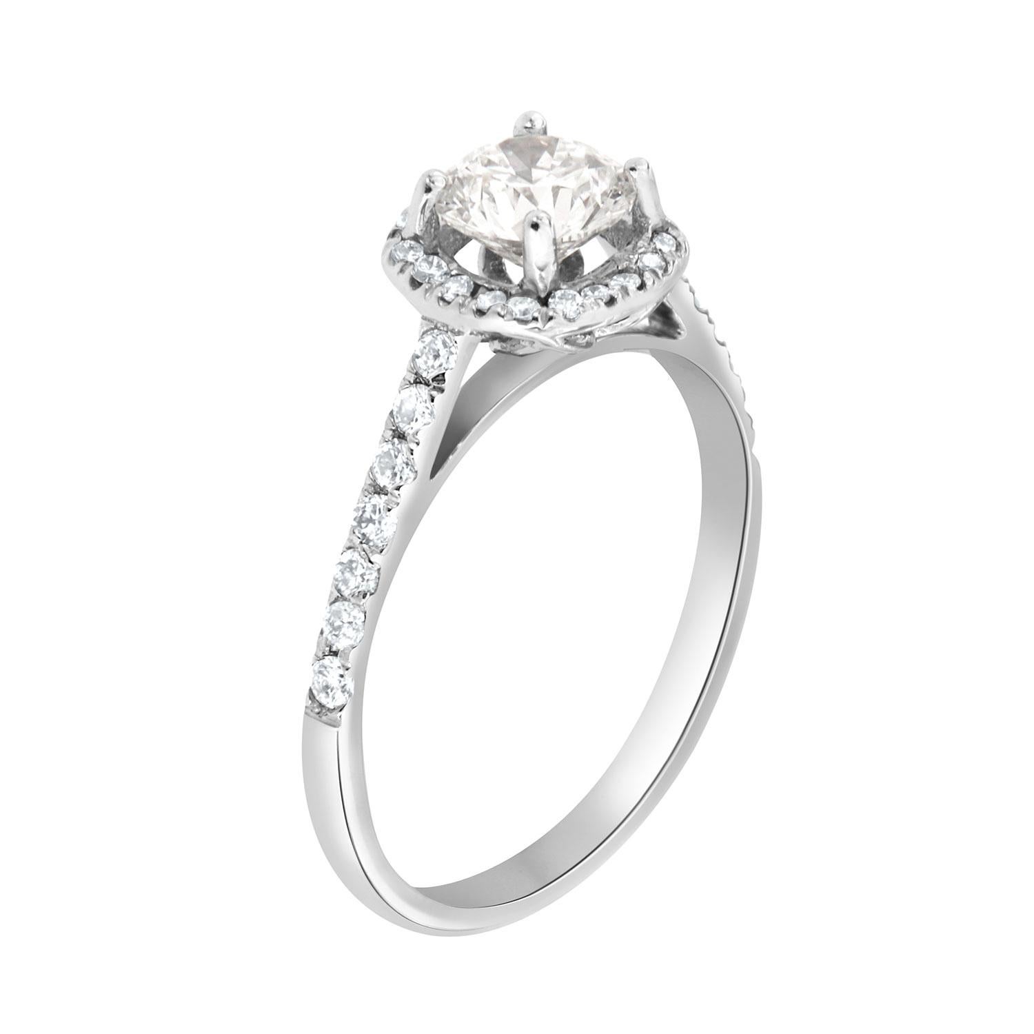 This Petite Cushion Shaped halo ring features perfectly matched brilliant round diamonds 1.3 mm each Micro-Prong set on a 1.7 mm wide shank. In the center of this sparkly ring is set one round diamond 0.70- Carat, E color VVS2 in clarity GIA