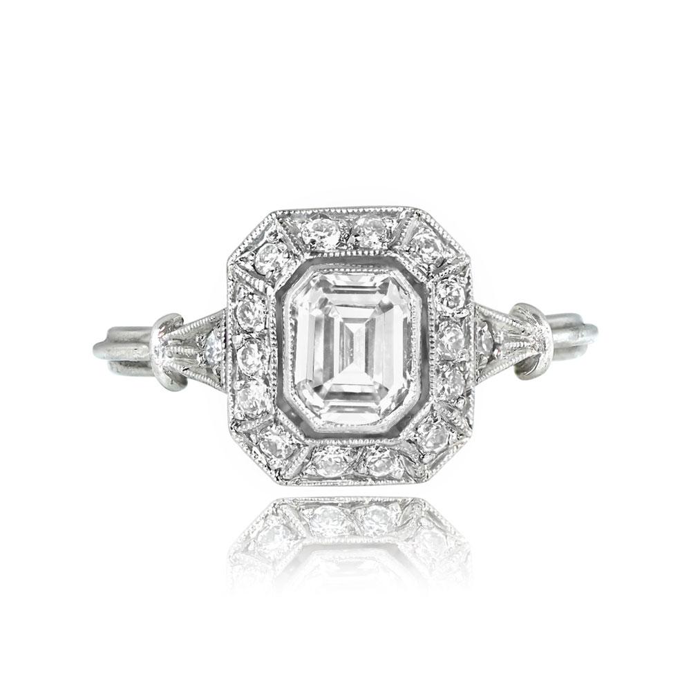 A diamond halo engagement ring showcasing a GIA-certified 0.71-carat emerald cut diamond with H color and VS2 clarity. The center stone is bezel-set and encircled by a row of old European cut diamonds, adding around 0.27 carats in total diamond