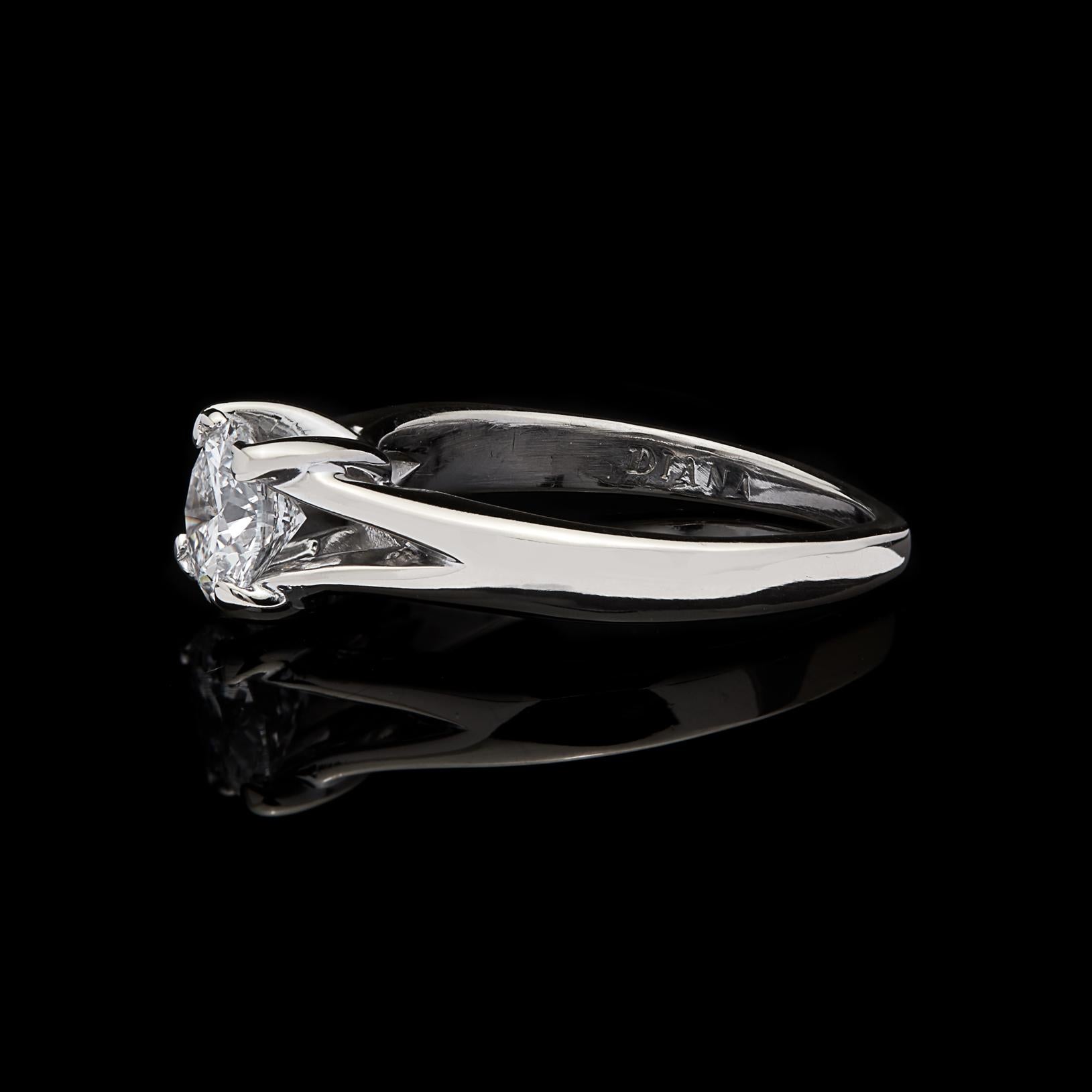 With top quality and beauty, this 18k white gold engagement ring truly shines. The 0.76-carat round brilliant-cut diamond is D color and VS2 clarity, set in 4-prongs on a split shank. The ring weighs 4.0 grams, and is currently size 5, with easy