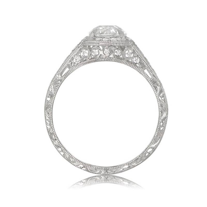 A sophisticated platinum and diamond engagement ring featuring a 0.77-carat old European cut diamond, certified by GIA as K color and VS2 clarity. The ring is embellished with diamonds along the shoulders, encircling the center stone, and on the