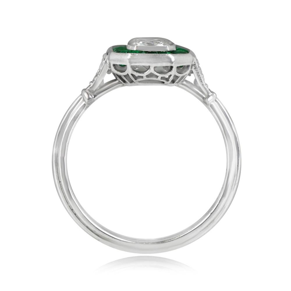 An exquisite halo ring showcasing a GIA-certified 0.80-carat emerald cut diamond with J color and VS1 clarity. The center stone is encircled by a halo of natural caliber green emeralds, totaling approximately 0.54 carats. Hand-crafted in platinum,