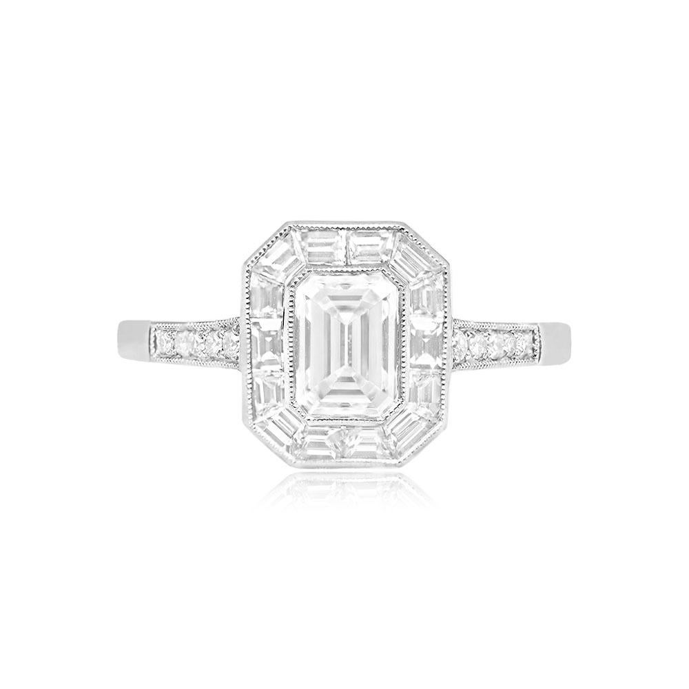 An exquisite ring highlighting an emerald-cut center diamond, certified by GIA, weighing 0.80 carats with H color and VS1 clarity, elegantly bezel-set. Enveloping the center diamond is a halo of baguette-cut diamonds weighing 0.44 carats, enhancing