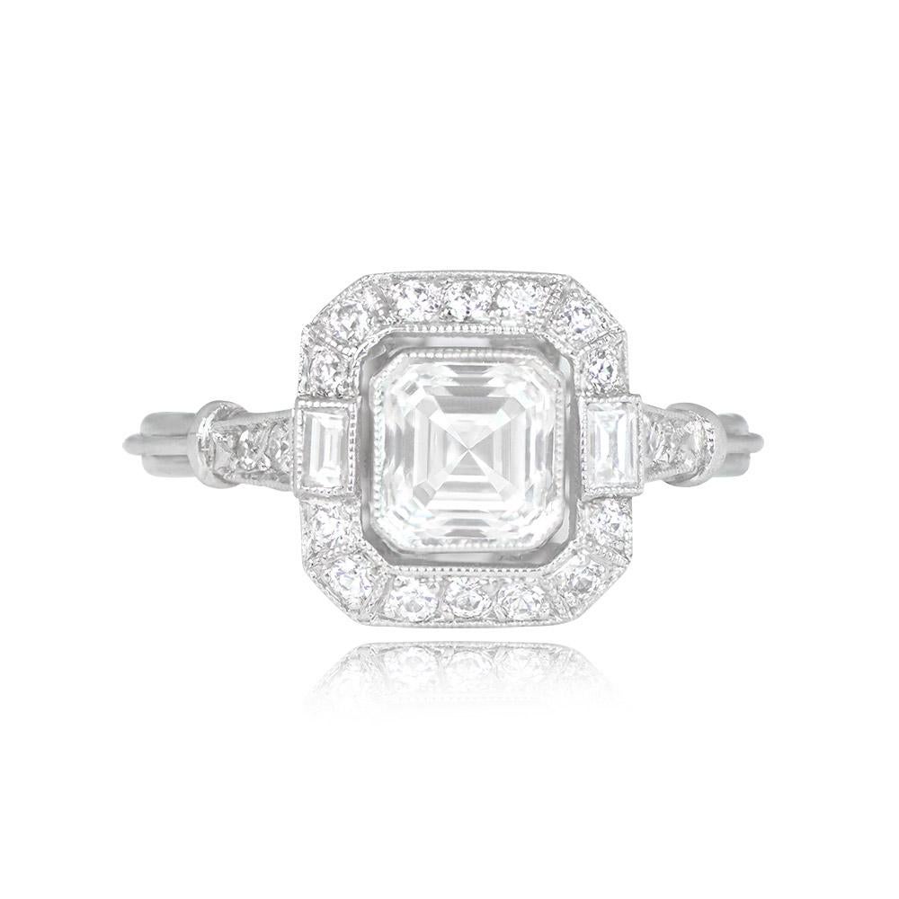 This striking engagement ring features a GIA-certified 0.89-carat Asscher-cut diamond at its center, with H color and VS2 clarity. The center stone is elegantly complemented by two baguette-cut diamonds and a halo of old European cut diamonds,