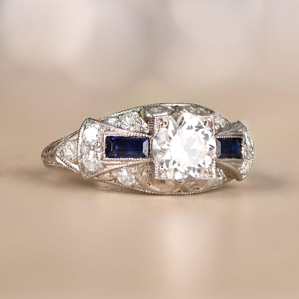 An exquisite Art Deco-style engagement ring with a GIA-certified 0.89-carat old European cut diamond, H color, and VS1 clarity. The shoulders showcase baguette sapphires, old-cut diamonds, and delicate filigree. Crafted entirely in platinum, echoing