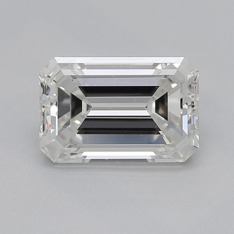 Handcrafted in New York, a stunning diamond ring that exemplifies timeless beauty and sophistication, featuring a captivating emerald center stone weighing 0.90 with a striking I and clarity of VS1. Its classic three-stone design is enhanced by two
