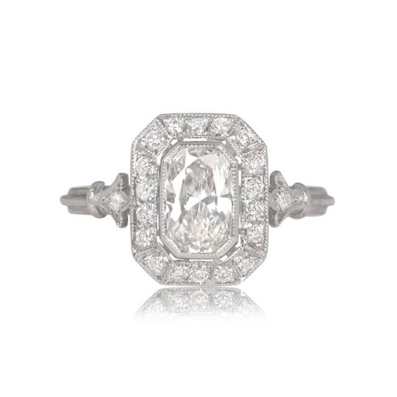 A geometric halo engagement ring showcases a vibrant GIA-certified 0.95-carat elongated cushion cut diamond, exuding an H color and SI2 clarity. The center stone is embraced by a rectangular diamond halo with cut corners. Adorning each shoulder are
