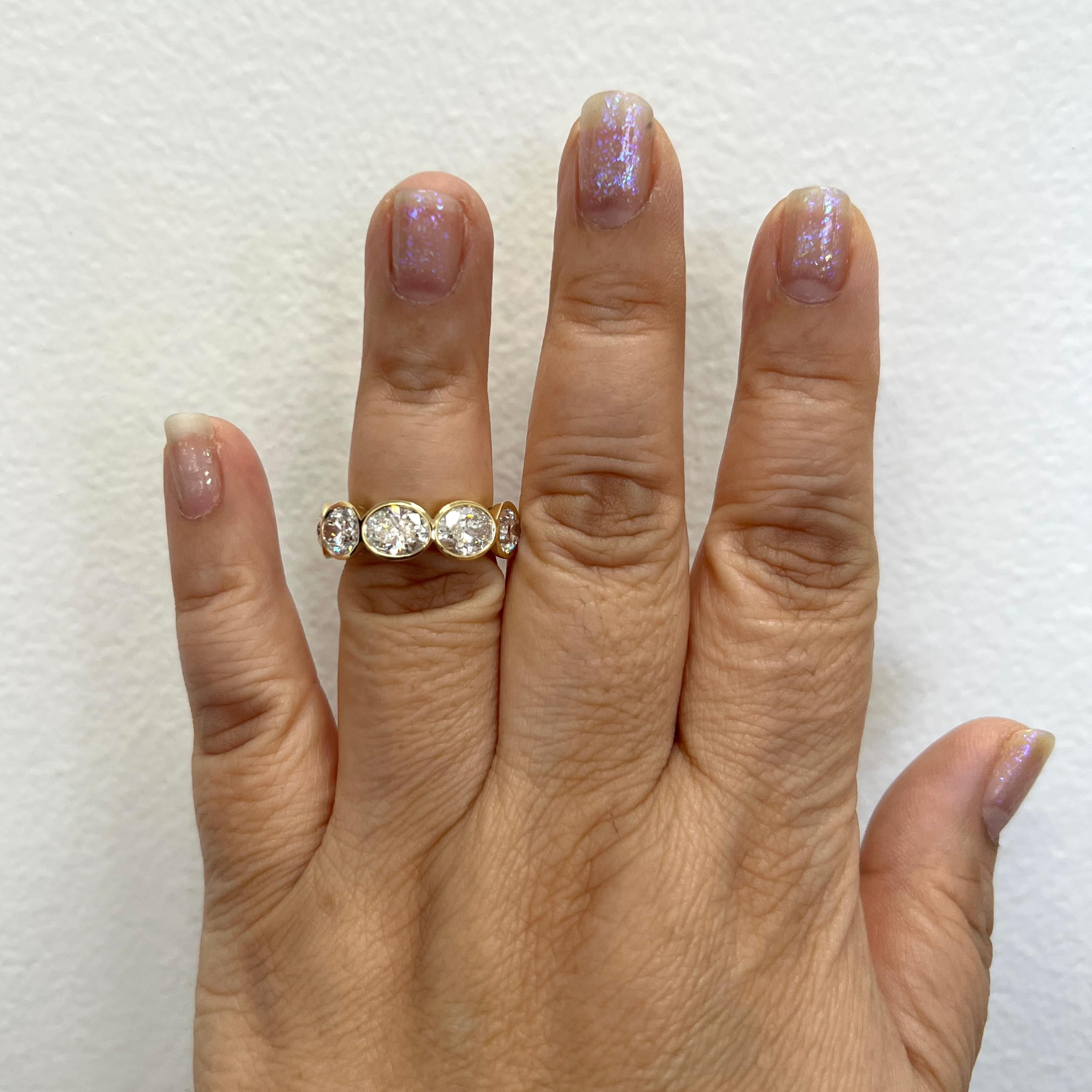 Stunning 9.02 ct. IJ SI white diamond ovals.  Total of 9 stones, 1.00 ct. each.  Handmade in 18k yellow gold.  Ring size 7.  Each stone comes with a GIA certificate.