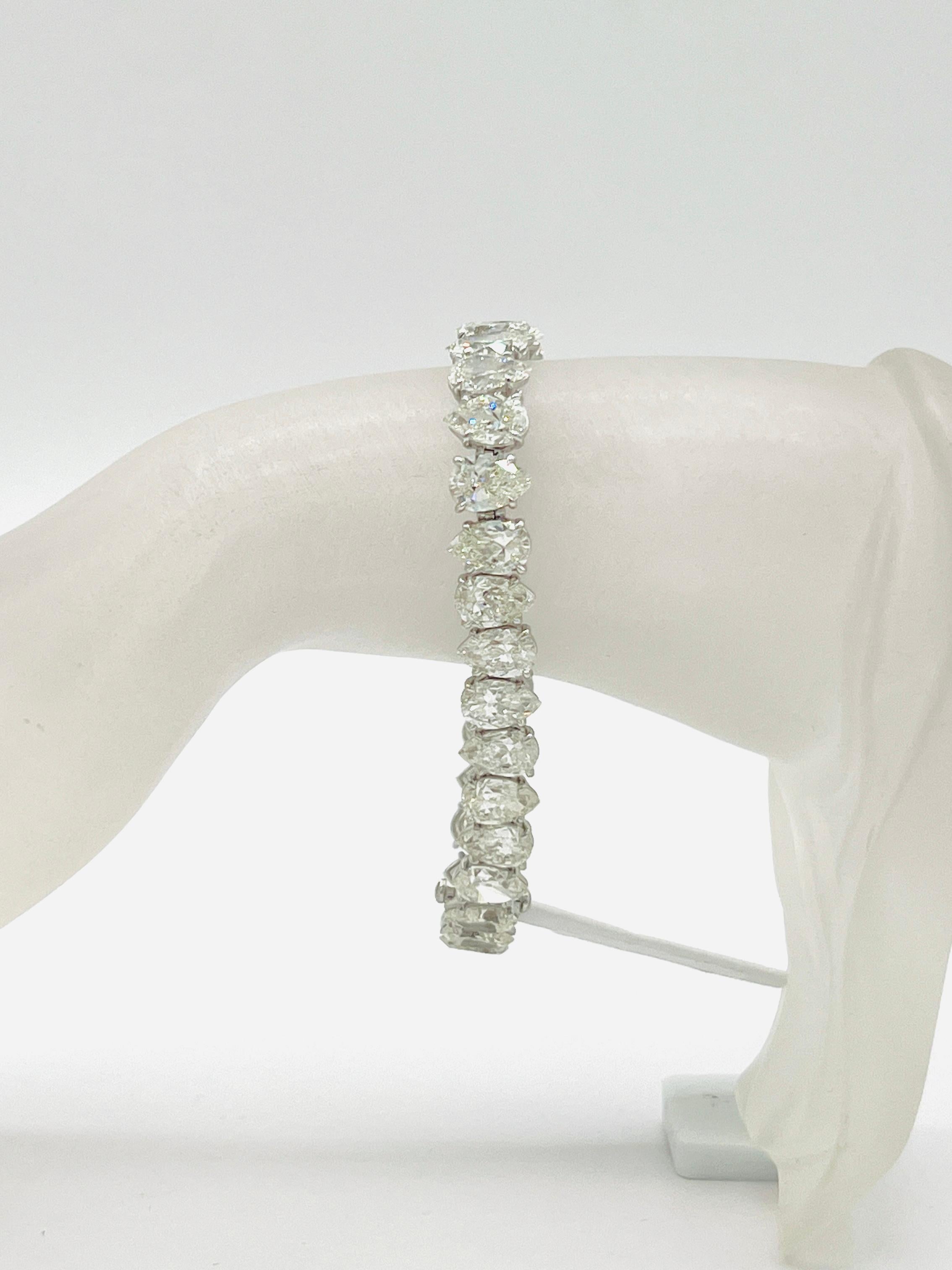 Gorgeous 32.07 ct. GHI SI white diamond pear shapes.  Total of 32 stones, each stone is 1.00 ct.  Handmade in 18k white gold.  Length is 7