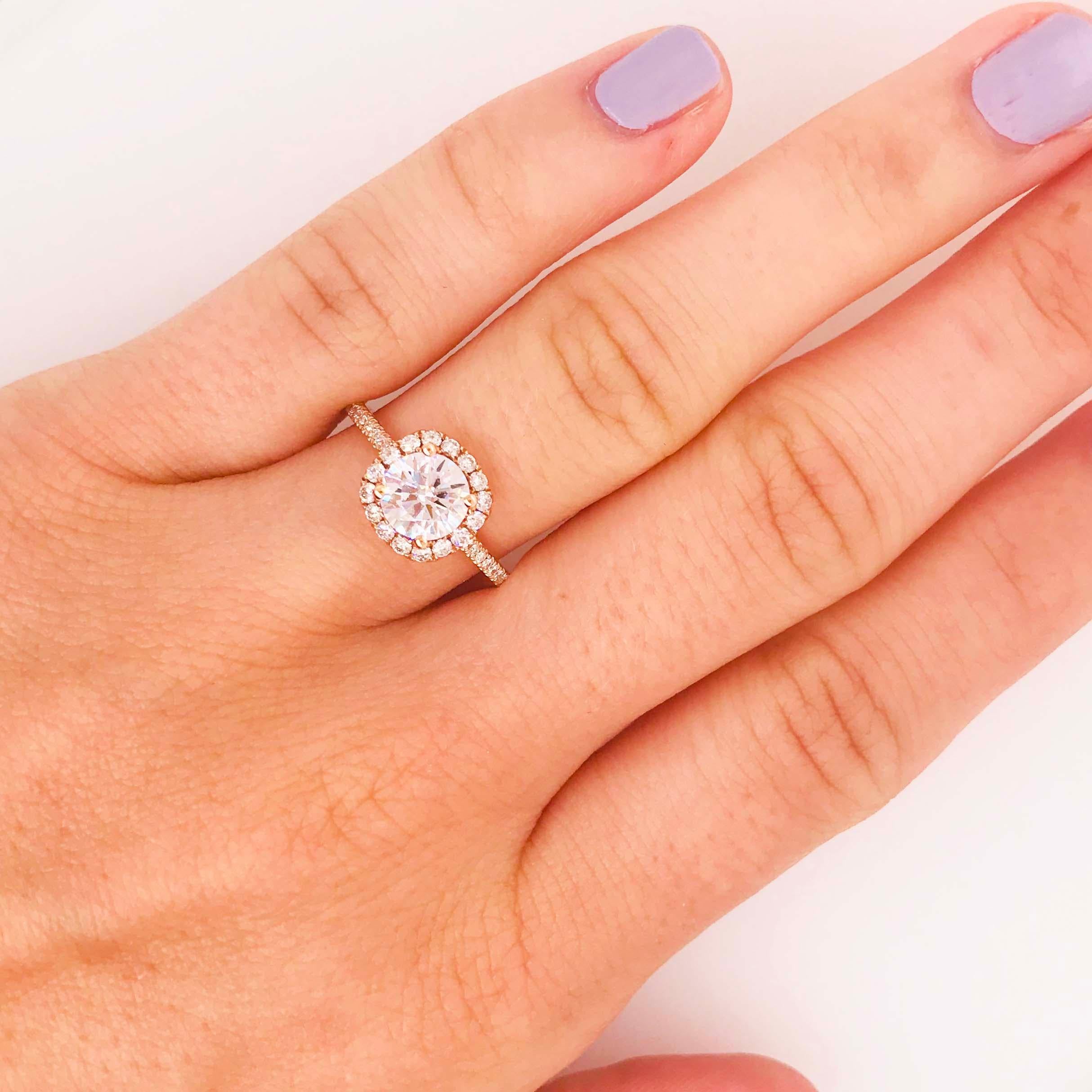 This diamond halo engagement ring has a round brilliant diamond GIA certified set in the center of a cushion shaped diamond halo! This engagement ring is classy and elegant! The engagement ring is 14 karat rose gold with bright white diamonds. The