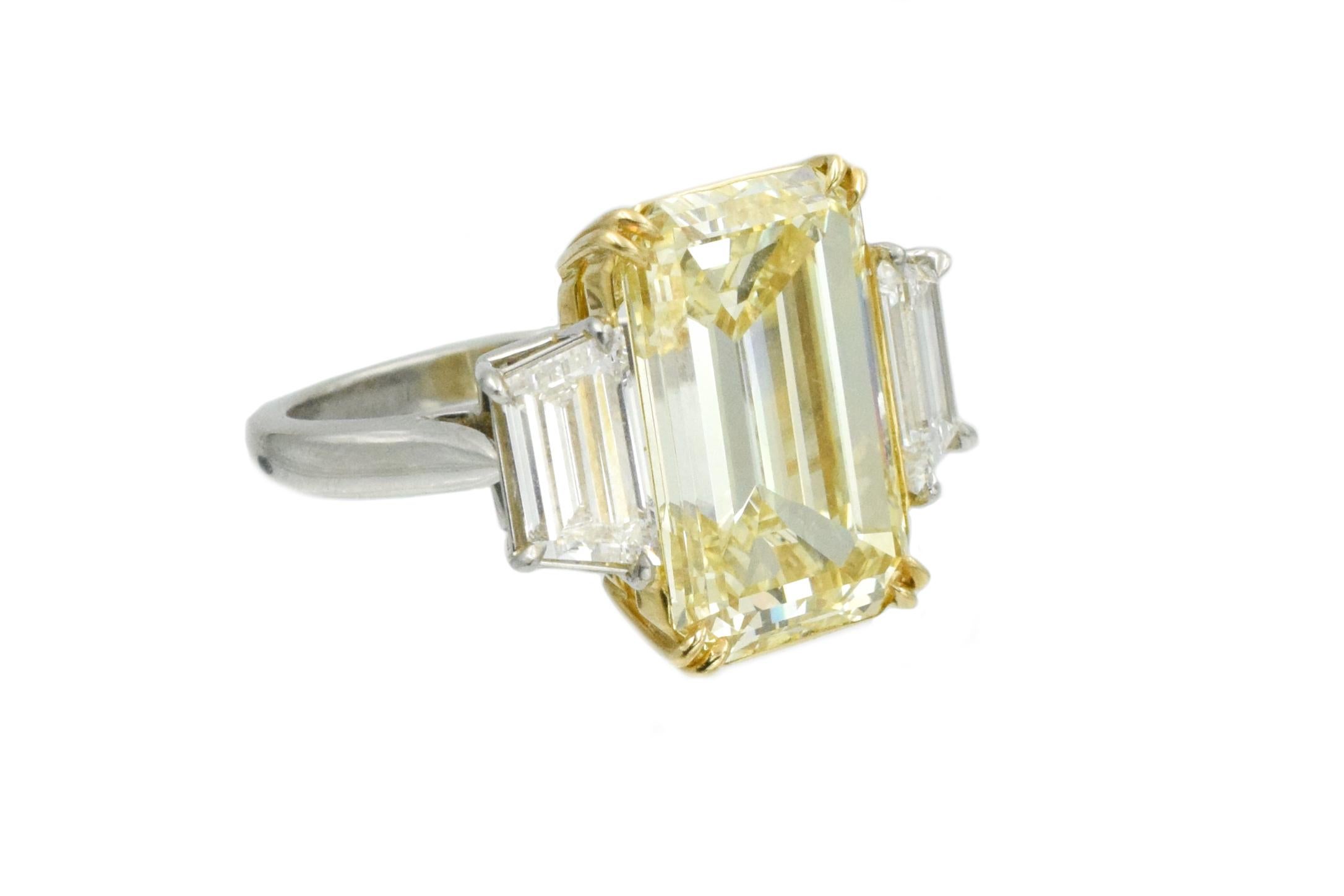 GIA certified 10.00carat rectangular cut diamond flanked by two trapezoid shape diamonds with total weight of  1.00carat 
10.00ct emerald-cut diamond, is color: Fancy Yellow, clarity: VS1 accompanied by GIA report # 1192155808.
Both trapezoids