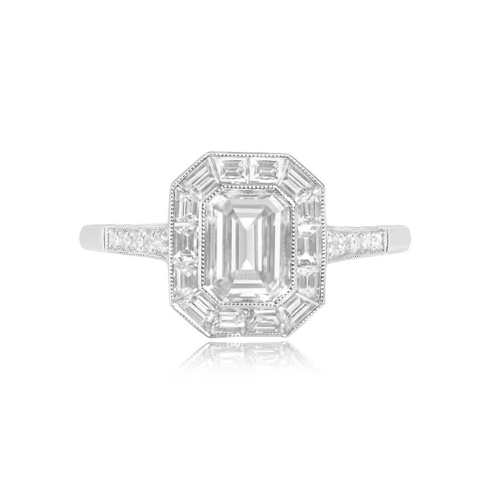 A stunning engagement ring showcasing a GIA-certified 1.00-carat emerald-cut diamond, elegantly bezel-set. Enveloping the center diamond is a halo of calibre baguette-cut diamonds, channel-set with an approximate total weight of 0.50 carats. The