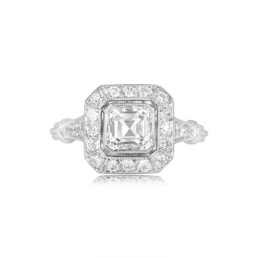 A captivating halo engagement ring showcases a GIA-certified 1.01-carat Asscher cut diamond, graded with J color and VVS2 clarity. An enchanting halo of diamonds, with a total approximate weight of 0.23 carats, gracefully accents the center stone.