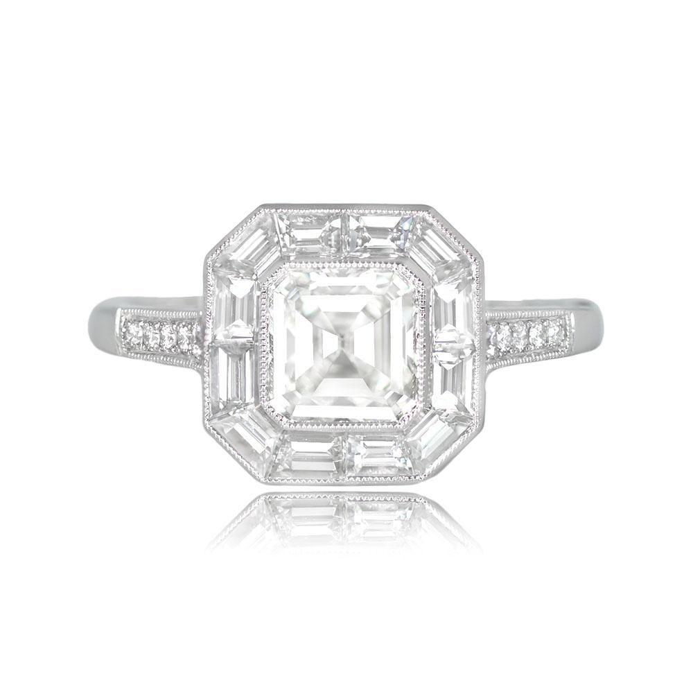 A geometric halo engagement ring with a GIA-certified 1.01-carat Asscher-cut diamond at its center. The diamond is of H color and VS1 clarity. It is surrounded by a halo of calibre baguette-cut diamonds, and round brilliant-cut diamonds line the