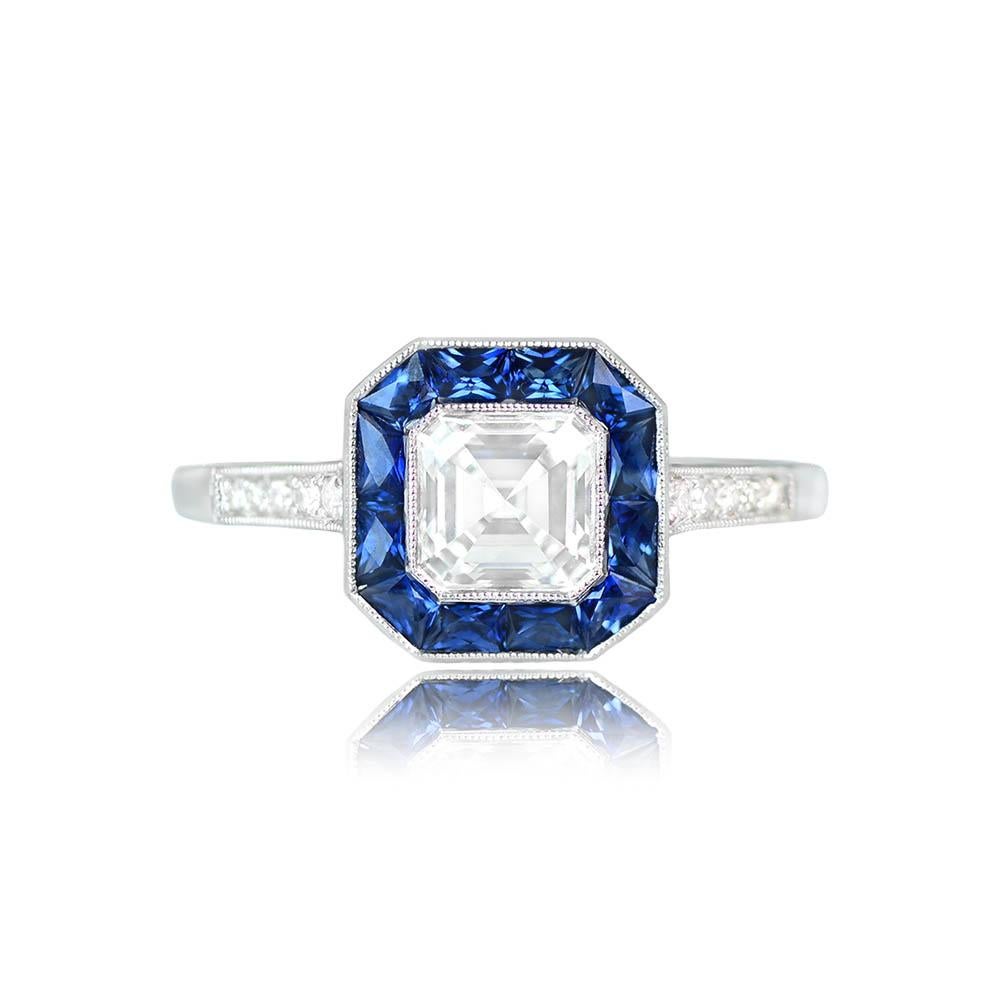 This elegant halo engagement ring showcases a GIA-certified 1.01-carat Asscher cut diamond (H color, VS2 clarity) in a bezel setting. Surrounding the center stone is a halo of French-cut sapphires with a total weight of about 0.72 carats. Old