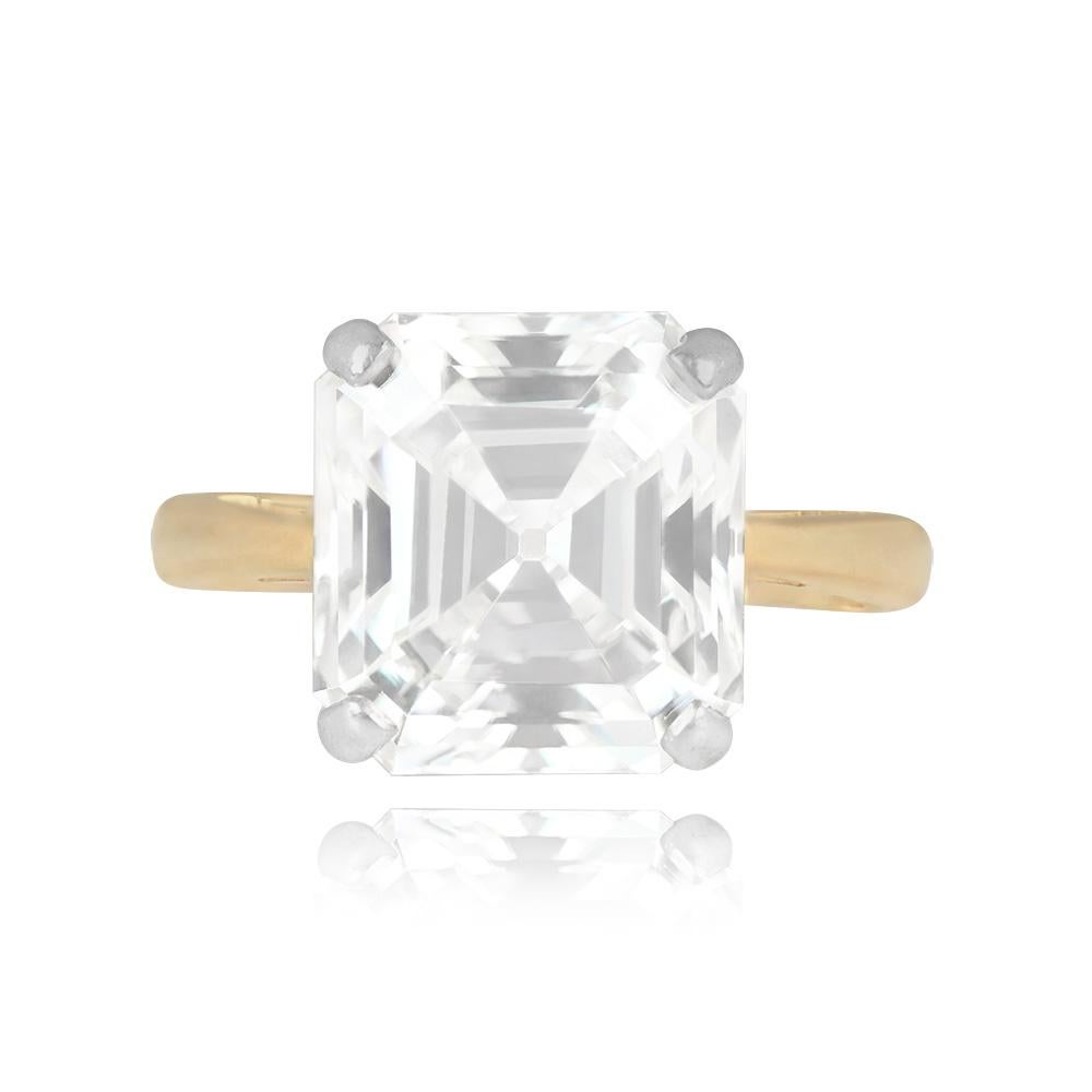 An impressive diamond solitaire ring with a 10.42-carat GIA-certified Asscher cut diamond, showcasing L color and VS1 clarity. This exquisite ring is crafted in a combination of platinum and 18k yellow gold, creating a striking contrast and